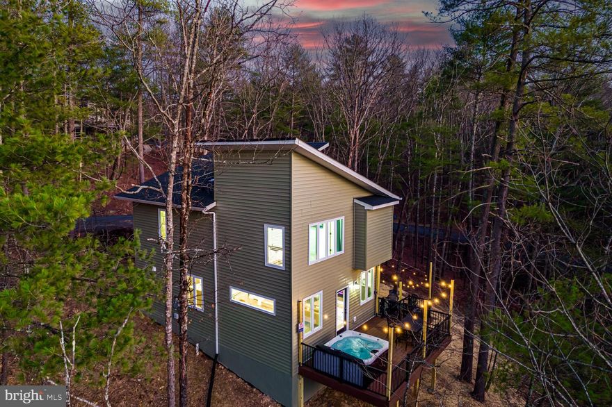 This contemporary detached home, built in 2024, is situated in the desirable Bryce Mountain subdivision, offering a blend of modern amenities and natural beauty. With a generous lot size of 0.47 acres, the property features a serene wooded backdrop and stunning mountain views, making it an attractive option for both homeowners and investors. The home boasts three spacious bedrooms and two and a half bathrooms, designed with an open floor plan that enhances the flow of natural light. Key interior highlights include upgraded countertops, recessed lighting, and a well-appointed kitchen with an island and pantry, perfect for culinary enthusiasts. The primary suite features a luxurious bath and a walk-in closet, while the living area is anchored by an electric fireplace with a stylish mantel, creating a cozy atmosphere. Additional conveniences include a main floor laundry area and modern appliances such as an electric oven, built-in microwave, and tankless water heater. The exterior is equally impressive, featuring durable vinyl siding and thoughtful landscaping. Enjoy outdoor living with multiple balconies, a spacious deck, and a porch, ideal for entertaining or relaxing. The property is equipped with a BBQ grill, exterior lighting, and flood lights for added security and ambiance. As an added bonus, the current owner's have added an EV charger to make life even easier. A gravel driveway provides ample parking space, while the gutter system ensures proper drainage. Nestled among trees, the lot offers privacy and a tranquil setting, enhancing its appeal for potential renters or buyers seeking a retreat-like atmosphere. The proximity to nature trails and outdoor activities adds to the investment potential, attracting those who appreciate an active lifestyle. This property is not only a beautiful residence but also a smart investment opportunity. The combination of modern amenities, a desirable location, and scenic views positions it well for rental income or future resale value. The association fee covers essential services such as common area maintenance, road upkeep, snow removal, and trash collection, ensuring low-maintenance living for tenants or owners. With the growing demand for contemporary homes in scenic areas, this property is poised for appreciation, making it an excellent addition to any real estate portfolio. Investors will find this property a compelling opportunity to capitalize on the thriving market in Bryce Mountain, where lifestyle and convenience converge.