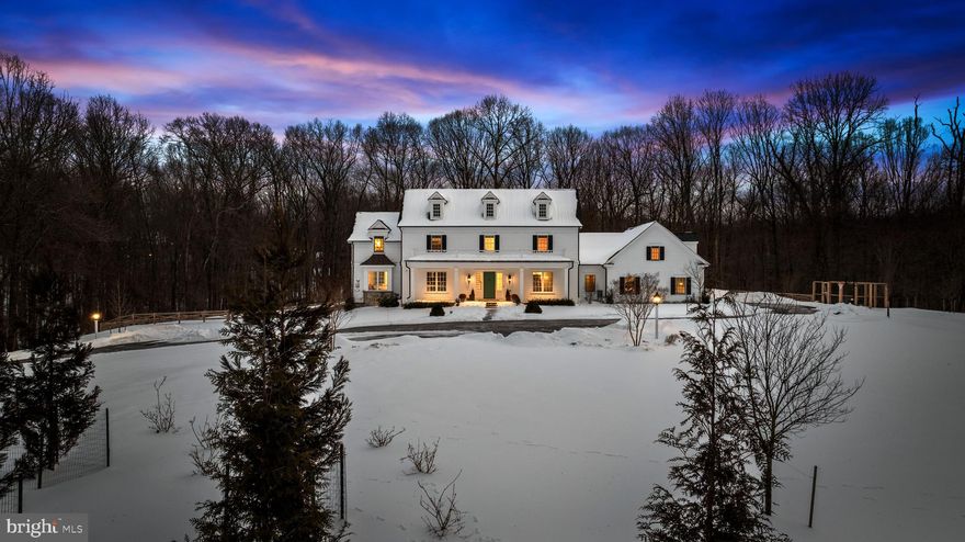Tucked behind the gates of one of Baltimore County’s most prestigious communities, this newly constructed 2023 estate embodies timeless sophistication and modern comfort. Accessed by a long private drive and surrounded by nearly 18 wooded acres, the residence offers complete privacy with sweeping 180-degree views of nature — a true sanctuary in the heart of the Falls Road Corridor. Spanning more than 7,650 square feet, the home showcases impeccable craftsmanship, exquisite millwork, and a seamless blend of classic and transitional design. The gourmet kitchen is a showpiece, featuring Sub-Zero and Wolf appliances and an open layout that flows effortlessly into elegant living and dining spaces. The spa-inspired primary suite is a retreat of its own, complete with heated marble floors, soaking tub, and a walk-in shower. With five ensuite bedrooms, six and a half baths, and thoughtfully designed gathering spaces throughout, this home balances grand scale with inviting warmth. Expansive grounds offer ample room for a pool or future outdoor oasis. A rare opportunity to experience unmatched privacy, luxury, and convenience — just minutes from all that Baltimore County has to offer.