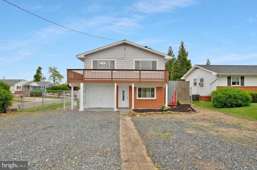 Welcome home to this beautifully renovated 4-bedroom, 2-bath residence offering stylish updates, flexible living space, and exceptional convenience. Situated on a desirable corner lot, this two-level home features a one-car front-loading garage plus ample driveway parking for up to four additional vehicles.  Step inside to find luxury vinyl plank flooring throughout the main level and upper living areas, complemented by fresh neutral paint and all-new lighting, including recessed fixtures. The thoughtfully updated bathrooms showcase ceramic tile flooring, quartz countertops, modern fixtures, recessed lighting, and high-efficiency WaterSense toilets.  The bright, white kitchen is a standout, featuring shaker-style cabinetry, quartz countertops, and a full suite of new stainless steel appliances—including a refrigerator with icemaker, built-in microwave, dishwasher, and flat-top electric range. Just off the kitchen, the dining area provides the perfect space for everyday meals or entertaining.  Upstairs, the spacious primary bedroom offers a ceiling fan and private access to a balcony deck—ideal for morning coffee or unwinding at the end of the day. Three additional bedrooms feature brand-new carpeting, while a versatile bonus room can serve as a home office, hobby space, or even a fifth bedroom.  The inviting living room is anchored by a fireplace with a classic brick hearth and wooden mantle, creating a warm and welcoming atmosphere. Additional highlights include a dedicated laundry/storage area with washer/dryer hookups, a new HVAC system, and a new hot water heater.  Outside, enjoy a covered patio overlooking a fully fenced backyard, complete with a shed and container storage—perfect for outdoor living and organization.  
Conveniently located near schools, shopping, and major commuter routes, this home is just minutes from downtown Baltimore, BWI Airport, and Fort Meade and one truly not to miss!