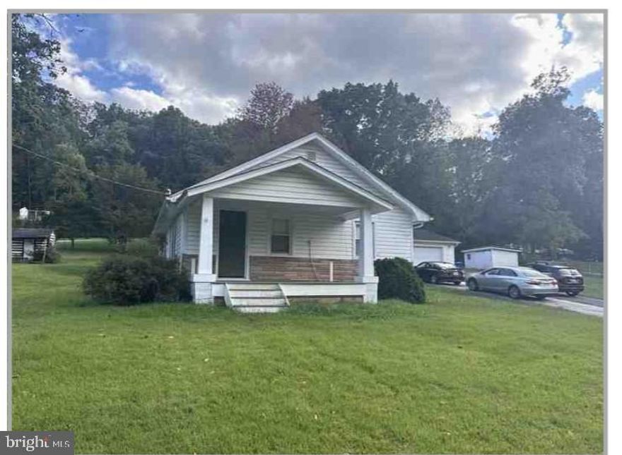 In a quiet corner of New Windsor, this cottage-style home feels like the kind of hidden find that sparks ideas instantly. With its classic profile, single-level layout, and wide-open lot, it offers a simple, inviting canvas ready for someone with vision. It has EBB heat. Inside, the home keeps things easy and bright. The living room brings in soft natural light, the two bedrooms offer comfortable proportions, and the kitchen has that appealing vintage character you don’t see in newer builds. Laminate flooring runs throughout, giving the entire space a fresh, unified feel the moment you step inside. Out back, the generous yard stretches behind the home, offering room to create an outdoor setup that fits your style — garden beds, a firepit, or space to finally stretch out and enjoy the outdoors. The detached two-car garage adds real versatility, whether you need storage, hobby space, or simply love having extra room to work. New Windsor’s calm setting adds to the appeal, with everyday essentials close enough for convenience and plenty of scenic back roads and open land surrounding the area. It’s a relaxed, easygoing place to put down roots. With an attic, basement, and enclosed porch, you also gain flexible bonus areas that support projects, storage, or future upgrades. Manageable in size and rich with potential, this hidden gem is ready for someone who loves the idea of shaping a home into something uniquely their own.