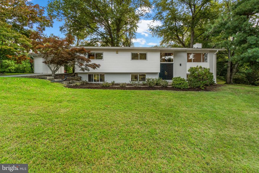 Welcome to your modern retreat nestled on .7 acres of nature-filled land in Berkshire Hills! Perfectly positioned among beautiful mature trees on a prominent corner lot, this beautifully renovated home offers the perfect blend of luxury and comfort. Head up the circular driveway to the convenient covered parking with convenient storage sheds. Additional parking is provided on the parking pad. Enter through the elegant double doors, you are welcomed by a stunning chandelier and timeless design throughout. The sleek staircase with iron spindles, handsomely refinished hardwood floors and beautiful backlit display cabinet anchor the main level, while the cathedral ceilings give an open and airy feel.  The living room directly adjoins the dining room with a huge picture window and built-in shelving. Head into the Chef’s Kitchen that has all the bells and whistles! With elegant quartz counters extending up the backsplash, stainless steel appliances, updated cabinetry with brushed gold hardware, and marbled porcelain tiles that make this room shine! The kitchen opens to a sunroom surrounded by nature with walls full of windows, a cathedral ceiling, and a designer light fixture. Access to the carport is conveniently located here for easy no-stairs access to the main level amenities.
Down the hall is a spacious owner’s suite with an adjoining upgraded full bath with a walk-in shower and two closets. Three additional bedrooms on this level are serviced by a stylish full bath with a double vanity and upgraded tiling. 
The lower level is ready for entertaining with durable LVP and wet bar! The rec room has a warm brick-surround fireplace and lots of space for hanging out. A fifth bedroom and a third stunning full bath provide privacy when guests are in town. This level has a huge unfinished area where you’ll find the laundry, a cedar closet and plenty of room for storage and a light filled workshop. Walk out to the side patio to enjoy the outdoors. It’s the perfect place to roast s’mores! A second brick patio with built-in seating is situated at the back of the house and overlooks the spacious yard. 
Close to major commuting routes, shopping centers & entertainment districts. This home has it all!