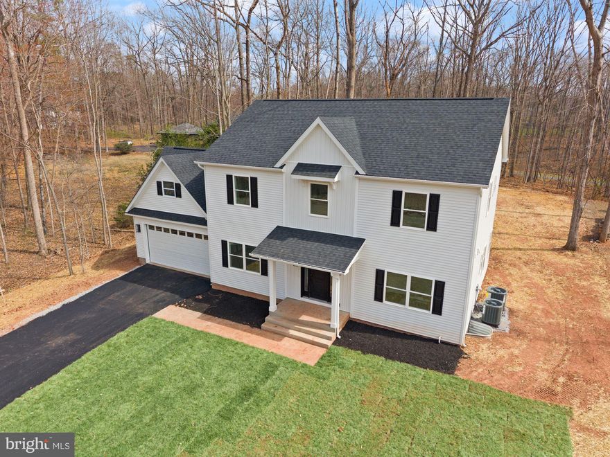 Finishing touches being added and will be completed in the next week, April 2nd! This home will be move in ready for a 30 day close!  Welcome to this stunning brand-new home, thoughtfully designed with high-end modern finishes and set on a serene half-acre lot—offering the perfect balance of privacy and convenience just minutes from commuter routes, shops, and dining. This home has 5 options that can be used as bedrooms but the septic is perced for 3 bedrooms but 6 person max occupancy. 

From the moment you step inside, you’re greeted by impressive designer details, including luxury LVP flooring throughout, a striking open staircase with iron railings, and elegant lighting complemented by recessed fixtures. The heart of the home is the beautifully appointed kitchen, featuring quartz countertops, a spacious center island, custom cabinetry, a stylish backsplash, and a statement range hood—all seamlessly open to the inviting family room with a coffered ceiling and cozy electric fireplace.

The main level also offers exceptional functionality with a mudroom off the garage, a pantry and butler’s pantry, a formal dining room, and a versatile office or guest suite complete with its own full bathroom.

Upstairs, retreat to the expansive primary suite with walk-in closets and a spa-inspired bath featuring a soaking tub. Two additional bedrooms share a Jack-and-Jill bathroom, and a generously sized laundry room with a utility sink adds everyday convenience.

The fully finished walkout lower level provides even more living space, including a media room, recreation area, an additional bedroom or office, and a full bath—perfect for entertaining or accommodating guests.

As an added bonus, the community offers private river access just a short walk away, creating a peaceful, nature-filled lifestyle.

This home is ready for immediate occupancy at closing, with a few final exterior touches underway, including driveway paving. Updated exterior photos will be available soon.