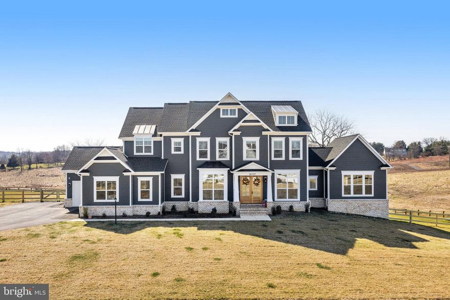 Elegant Living Redefined: The Glen Springs Grand Model at Ivandale Farm. Discover the pinnacle of luxury in this Glen Springs Grand Model by Carrington Homes, completed in September 2023. No need to wait for your dream home to be finished! Nestled on a generous 2 acre homesite in the peaceful Western Loudoun countryside of Ivandale Farm, this stunning property combines serene rural charm with convenient access to Route 7, Leesburg, and key commuting routes. Featuring an impressive 7,013 square feet of sophisticated living space, this home boasts all-around HardiPlank Siding, Double Mahogany Doors, and a 3-car garage. Inside, five bedrooms and 6.5 baths, including a deluxe In-Law Suite, offer ample space for family and guests. The heart of the home is a gourmet kitchen equipped with high-end Kitchen Aid Appliances, surrounded by hardwood floors, coffered ceilings in the family room, and elegant built-ins throughout. The deluxe primary suite serves as a private retreat, complete with vaulted ceilings, Palladian windows, and a luxurious bath featuring a plinth tub and frameless glass shower. Entertainment and leisure are seamlessly integrated with a side clubroom, extended rec room, game room/gym, and an outdoor oasis comprising a covered deck, screened-in porch, and an open-air deck. The Glen Springs Grand Model is more than just a home—it's a lifestyle offering unmatched luxury, comfort, and elegance. Perfect for those seeking sophistication and tranquility, this property invites you to experience the best of both worlds.