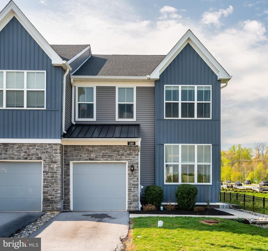 Welcome to 149 Ginkgo Lane, a beautifully updated 3-bedroom, 2.5-bath end-unit townhome located in the highly sought-after Villages of Chester Springs and within the award-winning Downingtown Area School District. Offering added privacy and one of the very few unobstructed views of the charming covered bridge, this home blends style, comfort, and convenience in an exceptional setting. Step inside to find gleaming wood flooring throughout the first level and an abundance of natural light that fills the home from front to back. The foyer is enhanced with elegant molding, creating a warm and refined first impression. To the left, a bright and spacious office provides the ideal setting for working from home or a quiet retreat. To the right, the dining area seamlessly connects to the inviting family room, where a cozy fireplace serves as the focal point. The open-concept layout continues into the upgraded gourmet kitchen, featuring a large center island, upgraded quartz countertops, stainless steel appliances, ample cabinetry, and a pantry for additional storage. Sliding doors lead to the rear deck, offering the perfect space for outdoor dining or entertaining. A stylishly updated powder room with custom woodwork and designer wallpaper completes the main level. Upstairs, the primary suite offers a relaxing escape with a walk-in closet and a beautifully appointed en-suite bath showcasing a double vanity and a walk-in shower. Two additional bedrooms are generously sized, filled with natural light, and enhanced with detailed molding, including a walk-in closet in the first secondary bedroom. A full hall bath with a tub/shower combination serves these bedrooms. For added convenience, a second-floor laundry room completes this level. The basement is already fully insulated, offering an excellent opportunity for future finishing to expand your living space. Ideally located, this home is walkable to local favorites such as The Stables, Liberty Union, Bloom, and Scoops Ice Cream, with exciting new shops and amenities— including a coffee shop, salon, and Celebree School—coming soon at the neighborhood entrance off Route 100. With its thoughtful upgrades, open layout, and prime location, this home is truly move-in ready and offers easy living in one of Chester Springs’ most desirable communities.