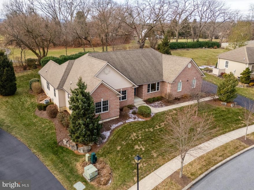 Situated on a premium golf course lot in Harvest Fields, this sprawling ranch home creates a warm and inviting atmosphere. As you enter through the foyer w/ hardwood floors that continue through the rest of the living space, you are greeted by the formal dining rm and opposite the office w/ French doors for a quiet and productive retreat. The open layout of the family rm flows into the kitchen,ideal for entertaining. The heart of the home is in the cozy family rm w/ gas fireplace, perfect for chilly evenings. Kitchen features include granite countertops, tiled backsplash, and a large pantry cabinet. Prepping meals is a joy in this delightful kitchen that includes a breakfast bar and dining area. Retreat to the master suite w/ a dreamy walk-in closet, featuring Creative Closets custom cabinetry. A roomy master bath w/ soaking tub completes the master suite. Two additional bdrms and a full guest bath are private from the living area. Convenient from the garage is a drop area and laundry room w/ access to the backyard. The finished portion of the basement is the perfect space for bonus living space and offers plenty of storage. Outdoors, the picturesque view from the backyard w/ outdoor lighting, allows for a private escape while sitting on the paver patio. Exemplary quality from International Builders. East Penn School District. Owens Corning basement system. Plantique landscaping design. This beautiful property is waiting for you to make it your forever home!