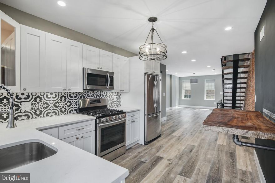 Sick and tired of every new home looking the same? Us too! Come take a look a look at this brand new, high design rehab just north of Powelton Village before it's too late! Welcome home to this three bedroom, one and a half bath home with thirteen hundred square feet just steps away from Lancaster Avenue and everything University City has to offer. Walk right in to an open concept living and dining space with wide plank hardwood floors, a single steel stringer stair case with refurbished oak wood steps and black metal railings. At the back of the home you will find a timeless kitchen with white shaker cabinets, white quartz countertops and Samsung appliances.  There's also a half bathroom on the first level with a barn door and wood feature wall. The master bedroom upstairs is well appointed with plenty of closet space and an exposed brick wall! There are two other bedrooms perfect for a guest room and an office space. Outback there is an oversized backyard perfect for your summer barbecue! The finished basement downstairs is extra living space with polished concrete floors and high ceilings. Walk Score of 91. Located less than a mile from Drexel University, this home qualifies for the Drexel Home Purchase Assistance Program with a $15,000 forgivable loan for faculty and professional staff members. For more information on the program, please look at Drexel's website.