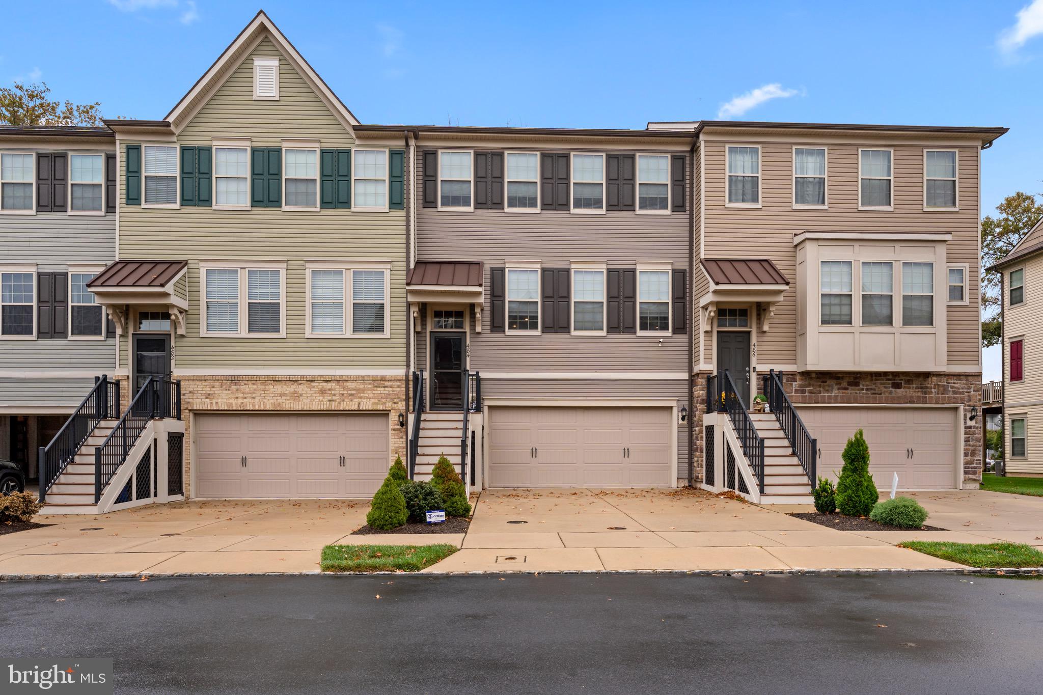 Welcome to 484 Rowan Street in the beautiful sought after Tall Oaks neighborhood. This newer built (2019) interior unit townhome features 3 bedrooms and 2.5 bathrooms with gorgeous finishes throughout. Enter into the foyer and up the stairs into a gorgeous open family room with plenty of natural light, and lovely hardwood flooring which spans all the way into the dining room and kitchen. The kitchen features wood cabinets, granite countertops, stainless steel appliances, and a lovely deck off the back, with easy access from the kitchen. The main level also features a powder room off the staircase. Head upstairs and be welcomed by your primary suite with a huge walk-in closet, wall-to-wall carpeting, ceiling fan, and a primary bathroom. The primary bathroom includes a large double vanity and sizable walk-in shower, as well as a separate toilet area. The washer and dryer are located conveniently next to the primary suite for easy access which eliminates hauling clothes up and down stairs. Both additional bedrooms feature wall-to-wall carpeting and ceiling fans with plenty of storage, and are located next to the hall full bathroom. This bathroom features a vanity with tub/shower insert, frosted glass, and beige tiling. The lower level features plenty of garage space with a 2 car garage with additional storage. There is a good size mudroom with added storage and utility closets. The downstairs den is a perfect spot for an additional family/living space, gym, or office. There is additional covered outside space off the bottom floor to enjoy the gorgeous neighborhood. Do not miss out on this great opportunity!
