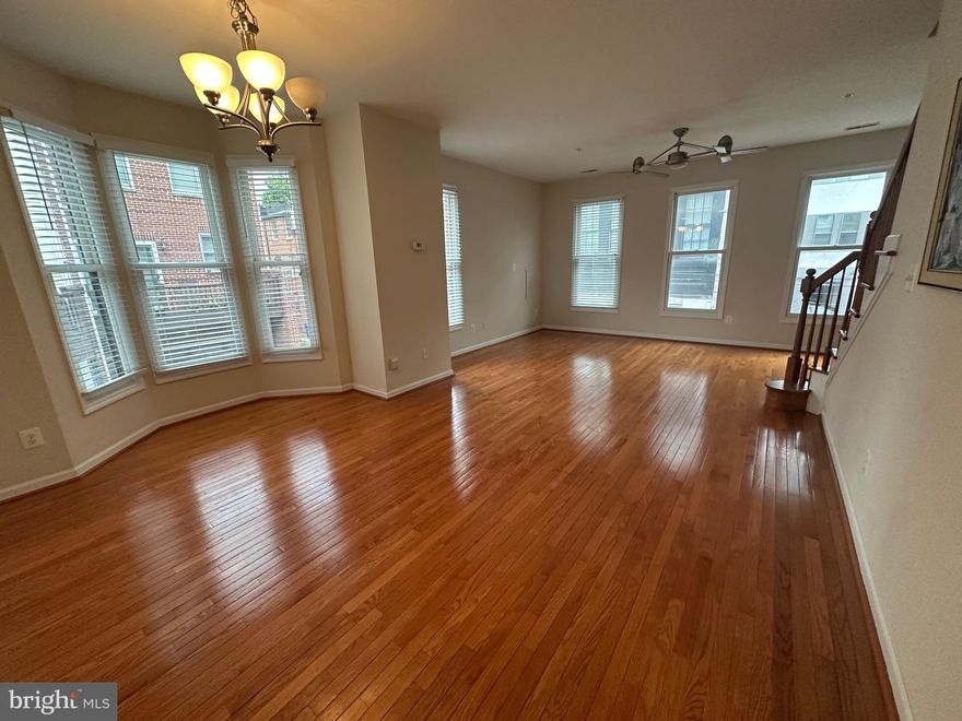 Rarely available, this brick home was built in 2007 and offers nearly 1800 sq ft on three floors with an ideal roommate floorplan, as each bedroom has it's own full bathroom. As you enter the home you will find a bedroom with ensuite bath, large under-stair storage and direct garage access. One flight up, the main level provides a large open floor plan with windows on three sides of the kitchen, dining and living areas. The kitchen has granite counters, stainless appliances, loads of 42 inch cabinets and tons of counter space to prep that gourmet meal you will be inspired to make in this airy kitchen! You will love the high ceilings, wood floors, powder room and balcony overlooking the rear courtyard/parking area that this floor also offers. On the top floor the primary bedroom has a spa-like ensuite bathroom, plenty of closet space and it's own balcony. The third bedroom also has it's own bathroom- no need to share! This sunny home feels almost new and is located on a small quiet street in Ridgely's Delight, just a block from Univ. of MD Medical Center and two blocks to Camden Yards. Available June 1st, minimum 12 month lease, multi-year lease preferred. Sorry, no pets or smoking.