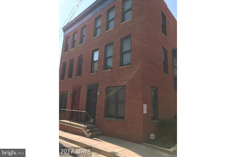 Rarely available, this brick home was built in 2007 and offers nearly 1800 sq ft on three floors with an ideal roommate floorplan, as each bedroom has it's own full bathroom. As you enter the home you will find a bedroom with ensuite bath, large under-stair storage and direct garage access. One flight up, the main level provides a large open floor plan with windows on three sides of the kitchen, dining and living areas. The kitchen has granite counters, stainless appliances, loads of 42 inch cabinets and tons of counter space to prep that gourmet meal you will be inspired to make in this airy kitchen! You will love the high ceilings, wood floors, powder room and balcony overlooking the rear courtyard/parking area that this floor also offers. On the top floor the primary bedroom has a spa-like ensuite bathroom, plenty of closet space and it's own balcony. The third bedroom also has it's own bathroom- no need to share! This sunny home feels almost new and is located on a small quiet street in Ridgely's Delight, just a block from Univ. of MD Medical Center and two blocks to Camden Yards. Available June 1st, minimum 12 month lease, multi-year lease preferred. Sorry, no pets or smoking.