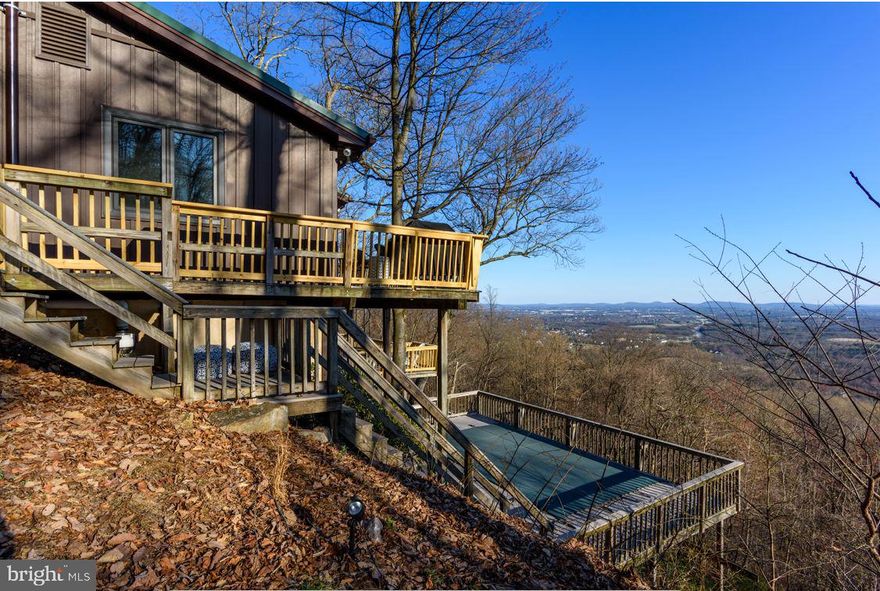 OWN YOUR OWN PIECE OF PARADISE! Perched atop the mountain, this private retreat offers stunning panoramic views and unmatched privacy on 12.9 acres of scenic beauty. Ideal as a primary residence, second home, or income-producing Airbnb, this property presents a rare opportunity to enjoy mountain living while generating short-term rental income. Guests and owners alike will be captivated by the large windows that frame breathtaking views from nearly every room. Relax by the cozy fireplace, unwind in the luxurious soaking tub, or step onto the expansive deck to take in unforgettable sunsets and star-filled skies. The setting offers the peace today’s buyers—and renters—are searching for. A detached garage provides ample space to store all your outdoor toys, making this the perfect base for adventure, relaxation, and escape. Private, peaceful, and incredibly versatile, this mountaintop retreat is a rare opportunity to own the view. Own the privacy. Own the opportunity!  A TRUE JOY!