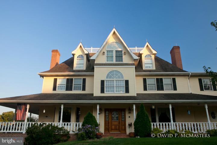 Highest quality construction. Incredibly lovely 21 acre pastoral setting, rolling land, stands of trees, peaceful, private. Extraordinary 4 level, 8176 sf, Victorian 6 FP's 9 ft+ ceilings, 6br., wrap porch, grand foyer, 50' in-ground pool. Superb gourmet kitchen. Wonderful views + light, 5 stall barn, fenced. Magical architecture. Horses welcome. Permitted for B+B. PRICE DROP OWNERS SAY SELL.