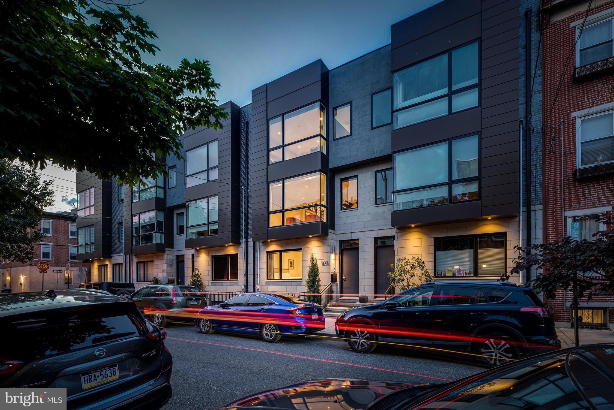 Welcome to 1839 Fitzwater Street - A 21 foot wide 3 bed 3 full bath luxury home with at least two car parking! One of five homes built around 2013, the development fully encompasses the Northeast corner of 19th and Fitzwater. At nearly 3,500 square feet, this home is truly special. Through the foyer find a first floor deluxe bedroom, a full bathroom and access to the suburban style garage. Up the stairs you are welcomed into a sweeping living, dining and kitchen area that extends the entire depth of the house. An impressive floor design hard to find in other offerings. The living room has floor-to-ceiling and wall-to-wall windows with direct sun exposure. Enjoy a large seating area with a tile surround gas fireplace. A dramatic architectural staircase with 4-inch thick oak treads is positioned between the living area and the dining/kitchen area. A beautiful focal point for this home. The kitchen is a perfect blend of beauty, comfort, and functionality–designed with attention to detail. The kitchen features Wolf, Sub Zero and Miele appliances, an enormous island with bar stool seating, honed waterfall granite counters, two sinks, wine storage and an additional wall of cabinets and prep space. Just off of the kitchen is a deck that runs the entire width of the home –an excellent place to BBQ or have a relaxing cup of coffee in the morning. On the south side of the third floor you’ll find a large guest suite with oversized floor to ceiling windows, a spacious en-suite bath and custom dual sided built-ins for at home work! Across the hall you’ll find the luxurious primary suite which is wide enough for a sitting area and features a tray ceiling, an ensuite bathroom with a double vanity, wall mounted faucets, a standing glass shower and separate water closet. Windows along the entirety of the back wall allow natural light to fill the room. The top floor is reserved for your wonderful roof deck - A massive bonus that provides a view of the sunset, sunrise and complete 180 degree skyline views! A beautiful place to entertain or peacefully relax. The enormous finished basement has endless possibilities. Currently a recreational room with a second living area and workout equipment. A space that can easily accommodate being converted into a 4th bedroom. On the back end of the basement you’ll find one of the best storage rooms in the city. You’ll have to see for yourself! Additional highlights include custom blinds and sheers, handsome oak floors throughout, expansive wall space for an art collection, third floor laundry and a car lift for a 3rd car option. At a depth of approximately 49 feet, this home has spectacular scale and proportions. The first resale of this community and not to be missed! An oasis in the heart of Graduate Hospital providing quick access to Rittenhouse Square, The Schuylkill River Park and Trail, 30th Street Station, University City, I-76 and SO MUCH MORE.