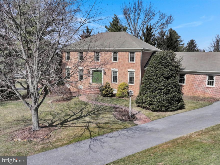 Grand Colonial!  Come visit this  East Hempfield gem...located along the 15th tee of the Four Seasons Golf Course.  A perfect blend of privacy with  coffee/shopping and entertainment only a few minutes drive.  The brick walkway and semi-circular steps provide a dramatic entry.   Inside the drama is repeated in the two-story  foyer...additionally you'll enjoy the formal spaces (LR and DR) that flank the large entryway.  The rear of the first floor provides hardwood flooring in the FR (with cozy FP) and allows for entertaining with FR and Kitchen in close proximity.  An expansive first floor primary bedroom was added to the rear of the home.  It provides a spa-like bath, large closets and a bedroom that is filled with light.  Upstairs are four additional bedrooms...3 traditional bedrooms, plus the original primary with an ensuite bath and oversized walk-in closet.  Large rear deck makes dining al fresco a breeze.  HVAC was just replaced in 2025 with warranty transferring to the new owner, many newer windows, plus large unfinished basement.   Come see and let the dreaming begin.