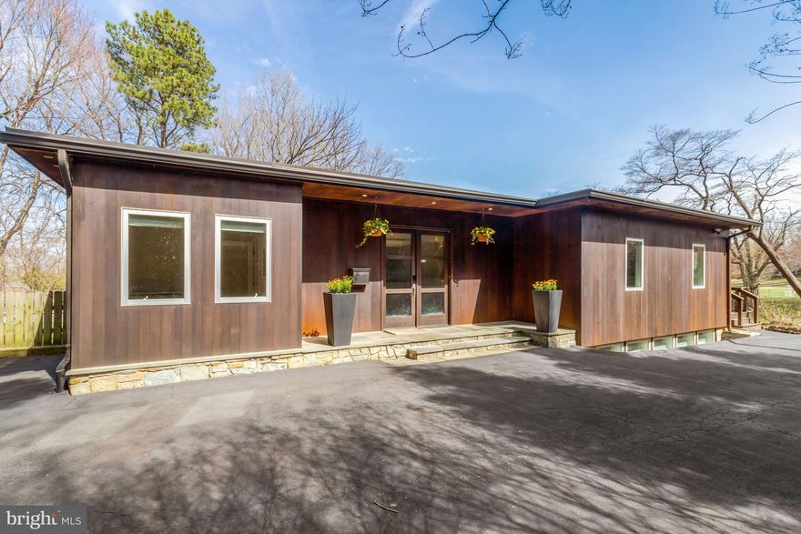 Not to be missed! Gorgeous cedar home with covered slate porch and walnut double-door entrance that brings you into the bright and welcoming foyer. This character-filled home, fully renovated in 2011 and beautifully cited on .4 acres, offers over 4,200 finished sq ft of comfortable living space across two levels, plus an expansive, easily accessible attic with 800+ sq ft for incredible storage possibilities and future potential. The open-concept main level features hardwood floors throughout. Natural light floods the space, maximized by oversized windows in the spacious family room and a vaulted kitchen ceiling. The family room is both cozy and functional, featuring a gas fireplace, custom built-ins, and direct access to the mahogany-plank front deck. This level has three bedrooms and two full baths, including the primary bedroom with a walk-in closet and ensuite bath. A sun-filled home office and a separate dining room complete the main floor.

A custom glass-paneled staircase leads to the fully-finished, walk-out lower level, with nearly 2,000 finished sq ft. This level offers a great option for multi-generational living, or as an au-pair or in-law suite, featuring a guest bedroom with an ensuite full bath and walk-in closet, two spacious recreation areas - the large game room easily accommodates a full billiards table and game day viewing set-up, adjacent to a second family room, music studio or playroom, as well as a dedicated workout room that conveys with high-quality gym equipment. A laundry room, second full bath and ample storage complete this level.

Enjoy the privacy of the fenced-in backyard and the convenience of the oversized detached garage. Big enough for four cars, with two double doors and an additional pedestrian door, the garage includes a fast level 2 EV car charging outlet and offers plenty of additional space for storage, bikes, lawn equipment, a studio, or a workshop. Finally, enjoy peace of mind with the whole house generator (with all new electrical updates in February 2026). Public water and public sewer. Ideally located well inside the beltway, just minutes to downtown McLean and Tysons Corner, as well as major commuter access to Chain Bridge and GW Parkway.