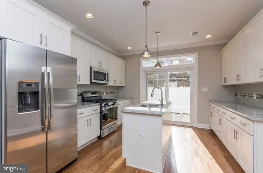 Move right into this beautiful large home on one of the most desirable streets in Point Breeze! This beautiful home was built only 4 years ago and has 6 years remaining on the tax abatement.  The home features a large living room with built in speakers and an open dining room showcasing any furniture arrangement to suit your taste. Continue into the newly designed kitchen, complete with granite counters, under cabinet lighting, stainless steel appliances, tiled backsplash and three sets of kitchen cabinets for plenty of preparation space with access through sliding doors to a concrete rear yard, perfect for entertaining! The second floor has 2 light filled bedrooms with ample closet space, and a full tiled bath with tub and shower. The third floor reveals an amazing master suite with large closets, trey ceiling with ambiance rope lighting, a full bath with a stall shower with a frameless glass enclosure. Be sure to notice  the 3rd floor's wet bar before heading up to the full sized roof deck with built in speakers and tons of built in lighting.  This home also comes with a full finished basement, with full tiled bath for your comfort & convenience.  Current owner added customized California closets! Do not miss your opportunity and make your appointment now!!