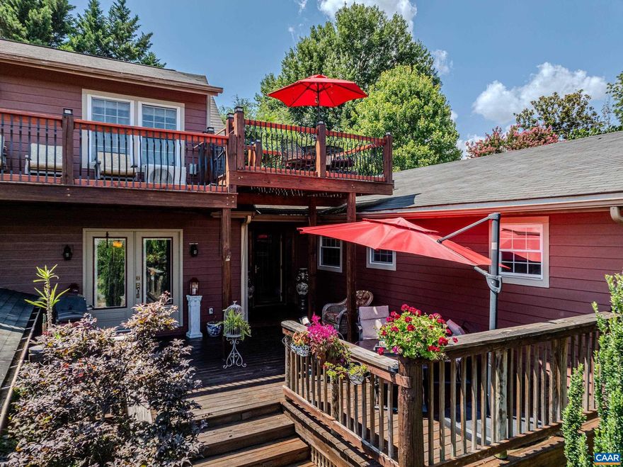 New Price and New HVAC! Luxurious, private outdoor living spaces, upgraded kitchen and spa-like primary bathroom make this a must-see home walkable to Downtown Crozet shops and restaurants.  You'll love the solid hardwood flooring with cherry finish throughout the home. The formal living room features a grand floor-to ceiling stone fireplace as a focal point, and also includes a separate media area. The gourmet kitchen features granite counters, custom cabinetry, a striking copper double bowl sink, stainless appliances and a generous island with a built-in grill. The kitchen opens to a spacious dining room that is great for entertaining. The main level features three additional bedrooms and a full bathroom. The second floor features a secluded primary suite with two spacious walk-in closets, and ensuite bathroom boasting a freestanding soaking tub and stunning walk-in shower. Enjoy a morning cup of coffee on the private roof-top deck. The outdoor living spaces at this home stun with over 1500 sqft of private patios and decks!  With an unfinished basement, storage shed/workshop, and two car detached garage this home is truly a gem! Current owners have rented as AirBnB on occasion but have no financial details to share.,Glass Front Cabinets,Granite Counter,Painted Cabinets,Wood Cabinets,Fireplace in Living Room