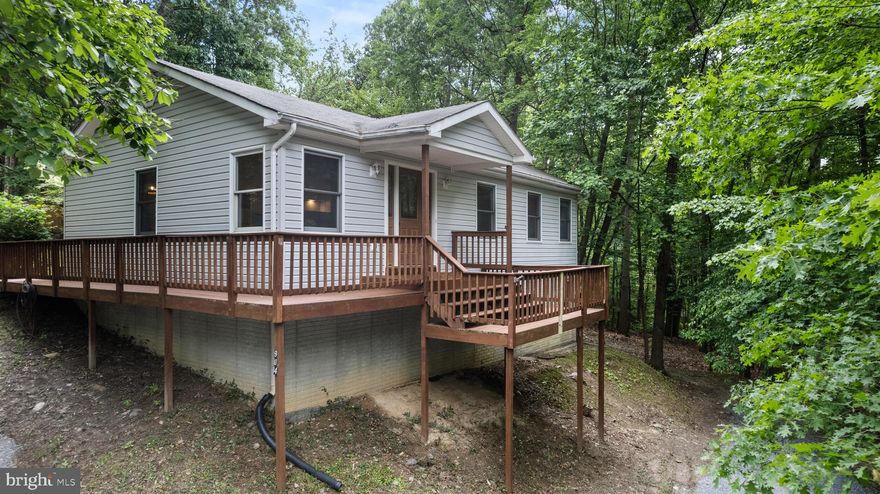 Welcome to your dream home! This beautiful two-story residence with vaulted ceilings offers three spacious bedrooms and two bathrooms, providing plenty of space for comfort and relaxation. The finished basement features an additional family/ rec room  and a generous storage area, perfect for all your needs. The home boasts stunning luxury vinyl plank flooring and plush carpeting throughout.

Step outside to a wonderful private  yard surround by trees and nature, complete with a shed and a chicken coop—ideal for starting your own backyard chicken farm. Enjoy the freedom of no HOA and the convenience of high-speed internet access.

Located near by is the Mountain Lake Club Beach, as well as a bar and grill, you'll have ample opportunities for leisure and dining. With public access to the Shenandoah River and two nearby convenience stores, everything you need is close at hand. The home's strategic location near the Maryland and Virginia lines makes commuting a breeze.

Make this dream home your reality today!