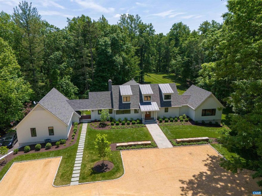 THIS CUSTOM IVY FARMHOUSE, situated on 10+ private acres, has all of the modern conveniences of a city home with the warmth and charm of a scenic country retreat. From the mahogany front door and restored rustic ceiling beams to the state-of-the-art integrated smart home system and luxury appliances, you will experience high-end current amenities coupled with tranquil elements of nature. The clean, sophisticated lines of the interior design and the serene landscaping are just 8 miles from Charlottesville, and 1.2 miles to Ivy Elementary. With plenty of parking and large open lawn, OWL'S ROOST is a great location for entertaining. Some additional features of this superb property include: an abundance of natural light, open floor plan, vaulted ceilings, large center island in beautiful gourmet kitchen, massive primary suite with luxurious marble bath, custom closet cabinetry, fully finished terrace level , an attached one bedroom apartment ( in-laws or nanny suite), several large decks and spacious screened porch, huge open lawn with beautiful landscaping and space for recreational activities, plus a stream and pond.,Quartz Counter,White Cabinets,Exterior Fireplace,Fireplace in Family Room,Fireplace in Great Room