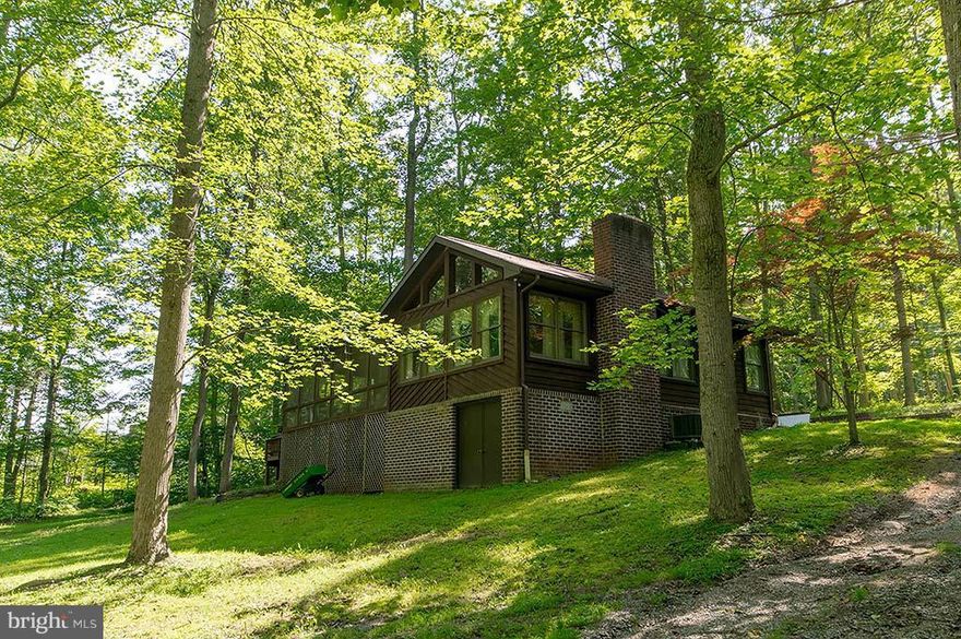 The Perfect Riverfront Retreat Awaits, bright and airy this 2 bedroom cedar cabin overlooks the Cacapon River with a very gentle slope to the rivers edge, allowing an unobstructed view of the water, but safe from the floods. Screen porch and lots of decking with a new hot tub for entertaining. Wood burning fire place, open floor plan with large kitchen. Plenty of room for the family. Call Today!