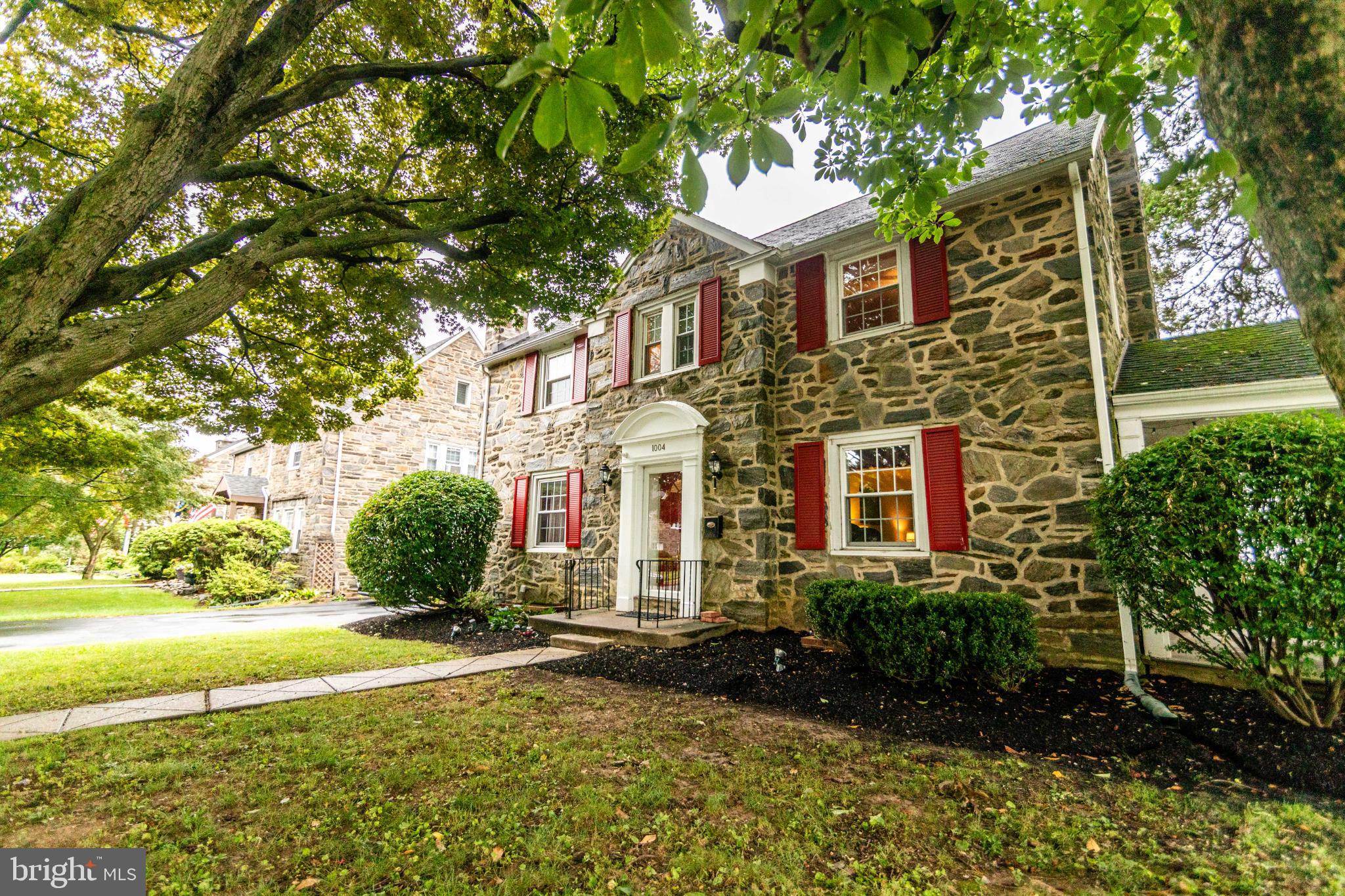 This charming stone, Colonial home in Drexel Hill offers a perfect blend of comfort and style. With four spacious bedrooms and two well-appointed full bathrooms and two half baths, this residence is designed for both relaxation and entertaining. The heart of the home features an inviting eat-in kitchen equipped with modern appliances, including a gas stove and dishwasher, making meal prep a breeze. Cozy up in the living room by the gas fireplace, framed by beautiful brick. There are gorgeous, built in cabinets in the large living room. You may also enjoy the fresh air on the covered porch. The interior boasts a thoughtful layout with hardwood, tile, and vinyl flooring throughout, ensuring easy maintenance and a warm ambiance. The partially finished basement provides additional living space, perfect for a playroom or home office, with convenient outside access. Step outside via a side door to a slate patio and also discover a level yard, ideal for outdoor gatherings or quiet evenings under the stars. The attic is partially finished, with A/C and heat in the finished area and also offers plentiful storage. Gas heating and cooking, newer HWH (2023), C/A, kitchen renovated (2018). All this and more….the property is enhanced by sidewalks and street lights, promoting a friendly neighborhood atmosphere. Located in a vibrant community, residents enjoy easy access to local parks, schools, and public services, fostering a sense of belonging. With ample parking, including a two-car garage and multiple driveway spaces, this home is ready to welcome you. Experience the warmth and charm of this delightful property, where every detail invites you to create lasting memories and make this your home sweet home.