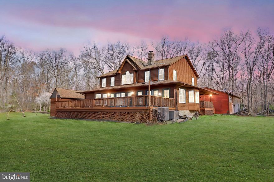 Welcome to 13329 Fredericksburg Trpk! Nestled on a serene 5-acre wooded lot, this stunning home offers the perfect blend of rustic charm and modern amenities. With nearly 3,000 sqft of living space, this property features a spacious main-level primary suite, four additional upper-level bedrooms, and two full baths, making it ideal for anyone seeking a peaceful and spacious retreat. The heart of the home is a stunning family room with vaulted ceilings, a large stone fireplace, and expansive windows that frame the backyard view. You're led into the beautifully updated kitchen, showcasing oak cabinets, stainless steel appliances, and granite countertops, including a brand-new cooktop (2024) and double oven, replaced in 2017. Relax and unwind in the cozy sunroom, or step out onto the expansive rear deck and wrap-around front porch—perfect for soaking up the gorgeous country views. You'll love the abundance of fruit trees, including peaches, apples, and avocados, along with flourishing concord grapevines and additional garden space. The property is equipped with smart thermostats and keyless entry for added convenience. Recent updates include a 2020 HVAC system, new carpets in 2024, replaced blinds, and an updated electric panel. For car enthusiasts or hobbyists, the detached 2-car garage/workshop is a dream come true, complete with a car lift, tire pump, and a generator that conveys with the property. With high-speed 1 gig internet, you'll enjoy the best of both worlds: the tranquility of country living while being just 5 miles from Bowling Green and under 14 miles from Spotsy VRE. This is more than just a home; it’s a lifestyle waiting for you! Don’t miss your chance to own this slice of paradise—schedule a showing today!