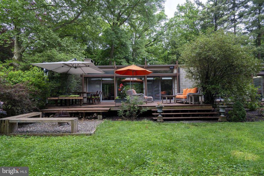 Welcome to 1015-1017 W Hortter, where mid-century modern style, high-end finishes, and manicured gardens converge. This stunning home is situated on a double lot, nearly one acre, on a quiet, tree-lined street in West Mount Airy. 
The house features three sizable bedrooms, a den, and two full bathrooms, all complemented by a walk-out basement. The interior boasts teak floors throughout, and natural light floods the space through extensive windows. The front of the house has windows that span half the wall height and run the entire length of the property. The kitchen is adorned with three oversized skylights and a glass slider, while the entire back of the house is floor-to-ceiling glass with five sliding doors. 
High-end kitchen appliances include a Viking range, Miele dishwasher, Bertazzoni wall oven, and Monogram beverage refrigerator. The large living/dining room, featuring a wood-burning fireplace, opens onto a spacious teak deck that extends the length of the house. Both bathrooms, the kitchen, and the entryway are adorned with Italian porcelain tiles. The primary bathroom is a luxurious retreat with a Kohler steam shower and an extra-large soaking tub. 
This home is just steps away from Wissahickon Park, the Upsal train station, and the vibrant neighborhoods of Manayunk and Chestnut Hill.