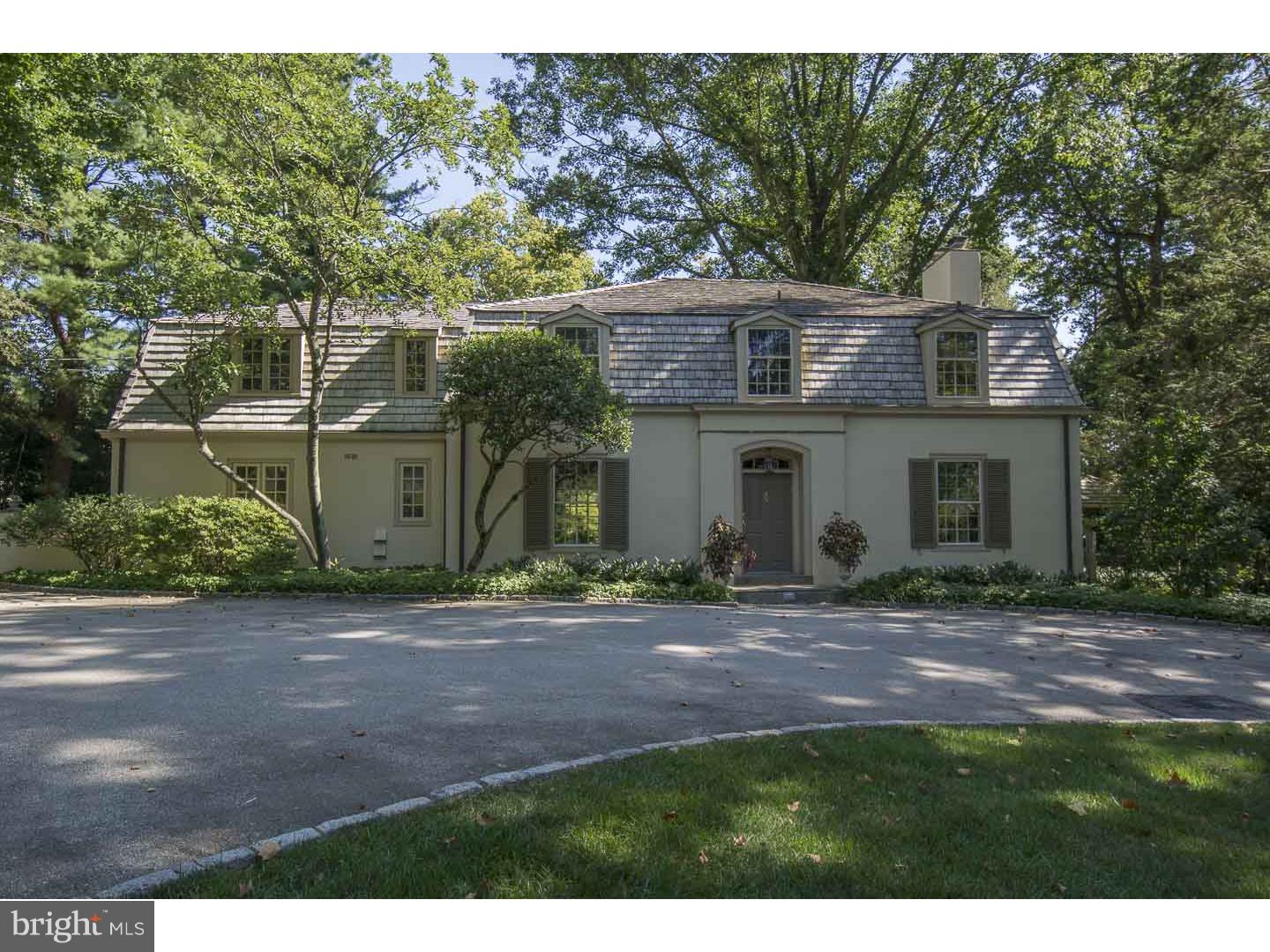 Set atop a slight rise and accessed by a wide, semi-circular driveway dotted with specimen, centennial trees, find this classically style 4-5 bedroom, 4 1/2 bath French colonial home on a spectacular 1.5 acre double parcel. Enter through a four panel door to a transverse Foyer with richly stained hardwood floors showcasing an open floor plan and connection to the Living Room, Dining Room and Den. Bathed in natural light, the formal Living Room features a wood burning fireplace with glazed tile surround and a full wall of windows and french doors leading to the blue stone Terrace, Pergola and beyond to beautifully proportioned Pool with slate coping. To the right of foyer is a handsome Den highlighted by corner wood burning fireplace and custom display and storage shelving offering requisite space for relaxing, working or informal gathering. Graced by a floor to ceiling bay windows flanked by French doors, the spacious Dining Room is positioned to enjoy a southern exposure and access to the Rear Terrace making it ideal for both formal indoor or al fresco entertaining. A service door leads to a large eat-in Kitchen. Generous flat prep space and warm toned solid wood cabinetry combine to create both a functional as well as inviting Kitchen and Breakfast Area, steps away from the rear stair, Mudroom and two car attached Garage. Second Level features a large bright Master Bedroom with His and Her Baths and outfitted, walk-in closet. This deluxe retreat space opens to a deep detailed wrought iron Balcony overlooking the rear yard and pool. A semi-circular metal stair gives private connection from the master balcony to the terracing below . Three Family or Guest Bedrooms connect to two full Baths while the fourth Bedroom is currently in use as an office with excellent light and convenient proximity to the Master Suite. Lower level is offered as primary storage and Laundry Room. A second fully subdivided and buildable parcel is included in this sale. Tax I.D. # 40-00-42240-01-1