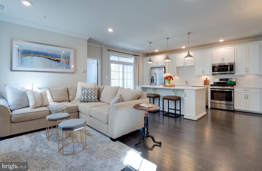 Gorgeous light-filled, end-unit condo located in amenity-rich Ridges at Loudoun Valley.  3 bedrooms, 2.5 baths with 1 car garage and driveway.  Stunning upgraded open concept kitchen with desirable quartz countertops, large eat-in island, GE stainless steel appliances, gas cooktop, subway tile backsplash and hardwood floors. Sizeable dining area is perfect for entertaining and opens to living room. Access the private covered patio through sliding glass doors. 3rd bedroom/office ideal for remote working. Convenient front load washer and dryer on upper level. Luxurious master bath with glass shower and quartz countertops.   Steps to clubhouse with fitness center, swimming pool, trails, and tot-lot.   Conveniently located near Loudoun County parkway, Dulles Greenway and future metro. Community amenities include Clubhouse, Fitness Center, 3 Pools, walking trails, community parks and much more!