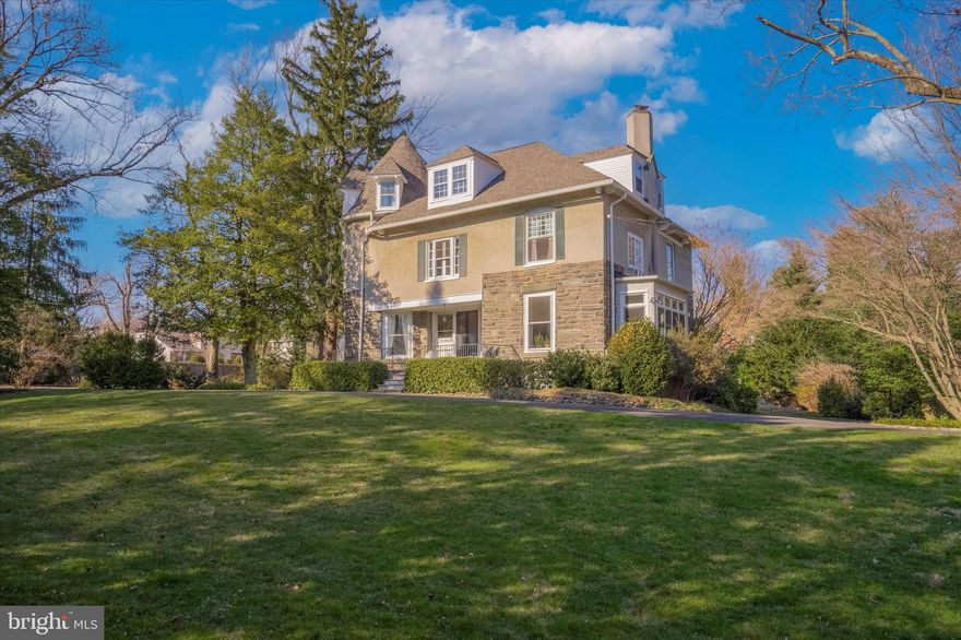 Just over the City border sits this one of a kind Circa 1870’s Victorian style masterpiece walkable to everything you need. Tucked behind a privacy hedge and fence on just under an acre,  this 6 bedroom 3 and a half bath home has been lovingly cared for and enhanced over the years. You are greeted by soaring 10’ ceilings, gracious light-filled spaces, incredible original detail, 7 original decorative tiled fireplaces, millwork and hardwood floors throughout. This home has a wonderful flow and spaces for everyday living and entertaining.  Just beyond the open renovated kitchen enjoy the dramatic family room addition with walls of windows, exposed stone wall, a wood burning fireplace, vaulted wood beamed ceiling and accessible to the expansive deck. In addition, enjoy more living space in the curved cozy den with fireplace and built-ins or in the sun drenched living room. The dining room also has access to the back deck. The gracious stairway leads to the second floor that offers 4 bright and spacious bedrooms including a lovely primary suite with a walk-in closet and a newly renovated bathroom that offers two sinks, a walk-in shower and tasteful finishes. Three additional bedrooms, a large finished storage room and a hall bath complete the third floor. The outdoor spaces are great for entertaining with the newly added covered porch with gas fireplace, mounted TV, ceiling fans and plenty of space to hang out. Improvements include, new roof in 2022, exterior & interior paint 2022, knob and tube wiring removed in 2015, outdoor covered porch with gas fireplace in 2021. Other features include oversized one gar attached garage, large driveway with plenty of parking and turnaround,  mini split in family room,  butlers pantry with wine fridge, first floor laundry area, walk out basement and much more. Take advantage of the Springfield Township School District. Walkable to Chestnut Hill and Wyndmoor’s restaurants and retail, Septa rail lines, the Wissahickon Trails, the Morris Arboretum, Woodmere Art Museum and so much more!