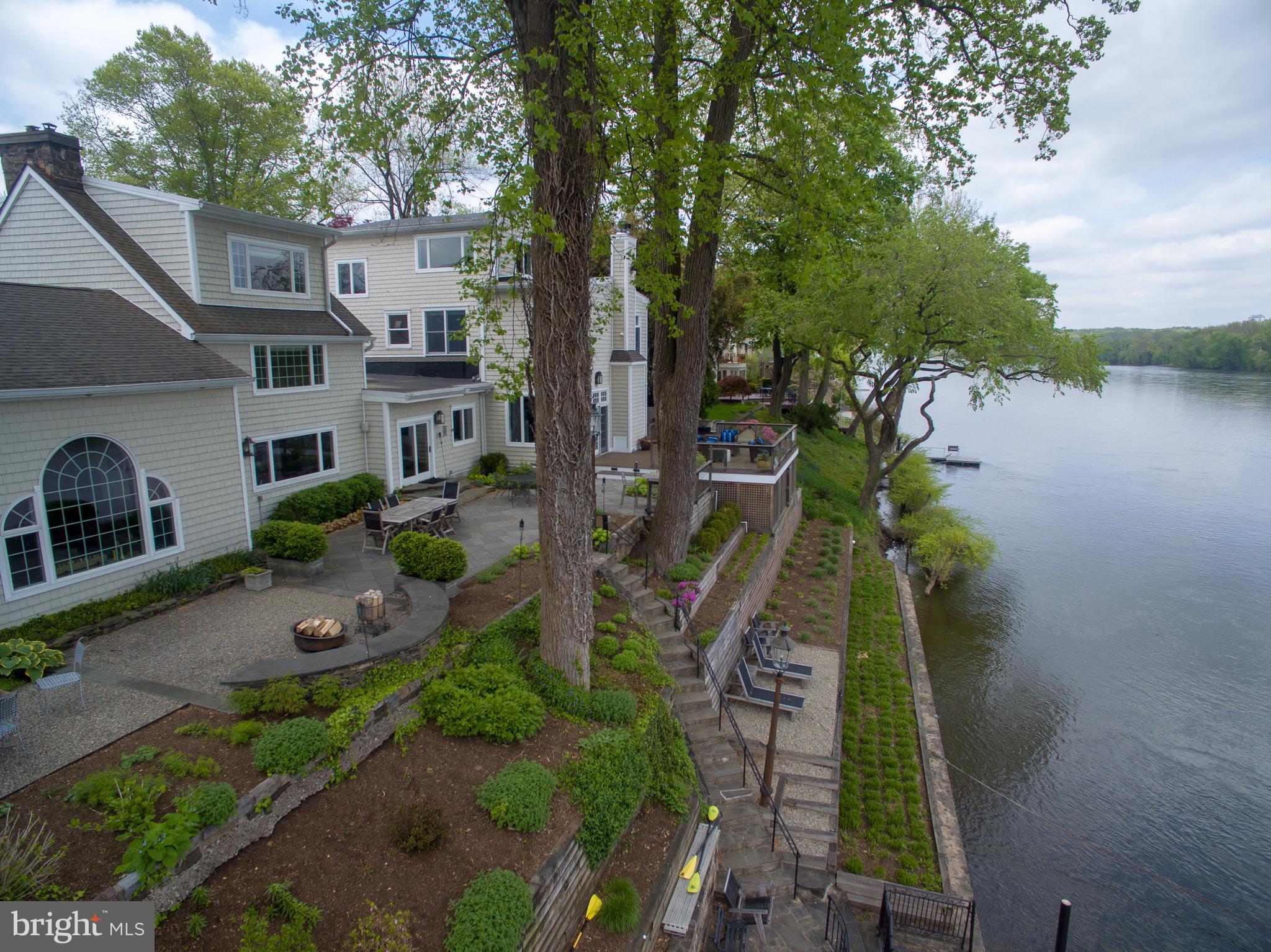 Boxwood Studio - an iconic stone Riverfront home located in a highly desirable and prestigious area of New Hope Borough. The spectacular sprawling 6600+ sq ft home offers 6 bedrooms and 5 full baths. There is a first floor bedroom with full bath ideal for in-laws, au pair or a guest room. The sumptuous Master Bedroom and bath with sitting room and 2 gas fireplaces have amazing views of the Delaware river. Boxwood Studio takes advantage of Pennsylvania stone both on the exterior and interior. Although the exterior depicts the proverbial Bucks County farm house the interior, with its open and continuous flow, has the sensibility of a mid century modern home. The expansive and open Kitchen and Breakfast area display high grade material and appliances. A blue tile accent wall with fireplace become the nucleus of the room. The adjoining Living room with wet bar flows into the Dining room and then large Family room with stone wall and woodburning fireplace. No matter where you look the views of the river are stellar and become the focal point of this home. The property provides one of the longest riverfronts in town. The unusually large outdoor entertainment space comprised of a deck and blue stone patios can accommodate the largest of parties or family gatherings. The stone walls cascade down to the river offering private access and lounging. Meticulously maintained, public water and sewer and less than a mile from one of the premier and highest achieving pre_K through 12 public schools in Pennsylvania. Boxwood Studio is one of the most sophisticated and stunning properties in all of Bucks County. It is truly a home that can provide decades of family enjoyment and a lifetime of memories.