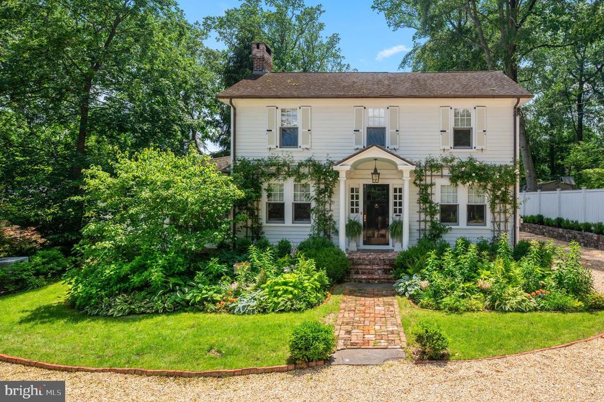 Celebrated in House Beautiful for its exquisite transformation, Edgewood Hall is the personal residence of acclaimed tastemaker Eddie Ross and partner Jaithan Kochar. Stripped to the studs and brilliantly reimagined, this 1923 center-hall Colonial blends fine craftsmanship, timeless elegance, and architectural soul. More than a home, Edgewood Hall is a Main Line icon. Nestled on a picturesque, tree-lined street just a stroll from downtown Wayne, this exceptional home marries historic grandeur with modern comfort. Mature landscaping provides privacy and beauty, while a pea gravel drive creates a gracious welcome. Step inside and it’s like entering a design magazine—every detail tells a story. Original wood doors and brass hardware have been meticulously restored. The layout flows effortlessly for elegant entertaining and daily life. The character-rich foyer sets the tone, flanked by formal living and dining rooms that reflect the home’s classic symmetry and enduring charm. In the living room, custom millwork evokes a private library, anchored by a wood-burning fireplace with a reclaimed mantle and marble surround. Cased openings lead to a vaulted garden room—once a porch—now bathed in natural light, with heated marble floors and panoramic views. French doors open to a brick patio and lush backyard oasis. Designed for the discerning host, the butler’s pantry blends luxury and utility with walnut countertops, a Marvel ice maker, and cabinetry lacquered in deep green. Felt-lined drawers protect silver and china, while bespoke touches—a brass sink, antique jade light, and tortoise-shell wallpaper—add warmth and character. As part of the home’s restoration, Ross designed a 730-square-foot addition with a gourmet kitchen opening to a sunlit family room, with living quarters above. The kitchen features custom cabinetry in brushed white oak with walnut interiors, wavy glass fronts, and hardware from Ross’s own line. Marble counters with green veining are paired with a full suite of Thermador appliances. The family room centers on a gas fireplace with a reclaimed mantle and brick surround. Two sets of French doors open to a terrace, enhancing flow and connecting to the grounds. Just off the kitchen, a detailed mudroom features brick floors, paneled walls, and an antique Dutch door. A copper tray inset into the floor is topped with a coconut husk rug—an inspired detail from a trip to France. Completing the first floor, the powder room features vintage wallpaper, crystal fixtures, and a swan-shaped brass faucet—an iconic detail from the Ritz Paris. As you ascend to the second floor, a brass inlay in the original handrail nods to the Cartier Love bracelet, while glass-capped stair rods add a jewel-like rhythm. Upstairs, Ross restored original doors, moldings, and hardware. Four bedrooms and two full baths include a grand primary suite with tray ceiling and built-ins. The en-suite bath features a walk-in shower clad in Kelly Wearstler tile and a vintage dresser vanity topped with marble and paired with brass fixtures.  Additional bedrooms include curated finishes and architectural detail. The hall bath features a soaking tub, brass fixtures, and vintage pendants. Ross also added a fourth bedroom and boutique-style laundry room with splattered wallpaper, a double-bowl apron sink, and a custom drying rack. Outside, the grounds are enchanting with custom trellises, mature plantings, and brick patios arranged for timeless charm and serenity. Plumbed for the garden enthusiast, the detached two-car garage—styled with carriage doors and a herringbone brick floor—feels more like an English potting shed than a typical outbuilding. Just minutes from downtown Wayne, this exceptional property is a rare architectural jewel, meticulously restored and reimagined by a celebrated tastemaker. A testament to preservation, craftmanship, and enduring Main Line elegance, Edgewood Hall is a once-in-a-lifetime generational offering.