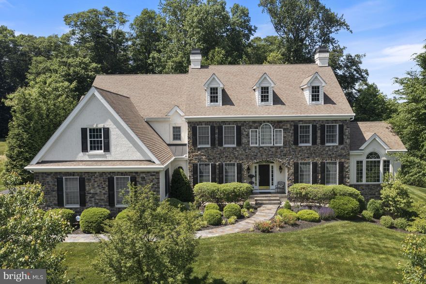 This stunning stone Colonial, nestled on a quiet cul-de-sac in the desirable Nivin View neighborhood of Landenberg offers exceptional beauty, elegance, and craftsmanship. Meticulously maintained, this impressive residence features 5 bedrooms, 4 full and 3 half baths, and sits on over an acre of picturesque land. A grand foyer welcomes you with classic millwork, detailed moldings, and gleaming hardwood floors. The formal living room flows seamlessly into a bright and inviting sunroom through elegant French doors. A private office with coffered ceiling provides the perfect work-from-home space. The formal dining room connects to a well-appointed butler’s pantry complete with wine fridge, beverage fridge, dishwasher, and sink. The gourmet chef’s kitchen is a showstopper, featuring top-of-the-line appliances, custom cabinetry, a large center island with seating, and a sunny breakfast area. The kitchen opens to a spacious family room highlighted by a striking stone fireplace, hardwood flooring, and expansive windows that flood the space with natural light. The main level also includes 2 powder rooms, a mudroom, and access to the attached three-car garage. Upstairs, the luxurious primary suite offers a private retreat with gas fireplace, tray ceiling, built-in cabinetry, and three custom walk-in closets. The spa-like en-suite bath features separate vanities, a large tiled shower, and a soaking tub. Two additional bedrooms share a Jack-and-Jill bath, while a third bedroom includes its own private bath. A convenient second-floor laundry room completes this level. The finished walk-out lower level is designed for entertaining and relaxation, boasting a theater room with tiered seating, a full bar with granite countertops, dishwasher, refrigerator, and sink,  powder room and media room, along with additional guest suite with full bath, walk-in closet and laundry room - the perfect, private space for family and guests. Outdoor living is equally impressive with a large fieldstone and brick patio off of the kitchen as well as a smaller patio off of the lower level - both overlooking serene wooded surroundings. Additional features of this home include a whole house generator, newer HVAC units and finely manicured and designed landscaping and hardscaping. Ideally located just minutes from Longwood Gardens, downtown Kennett Square, Hockessin and Wilmington, this home offers the perfect balance of privacy, luxury and convenience.