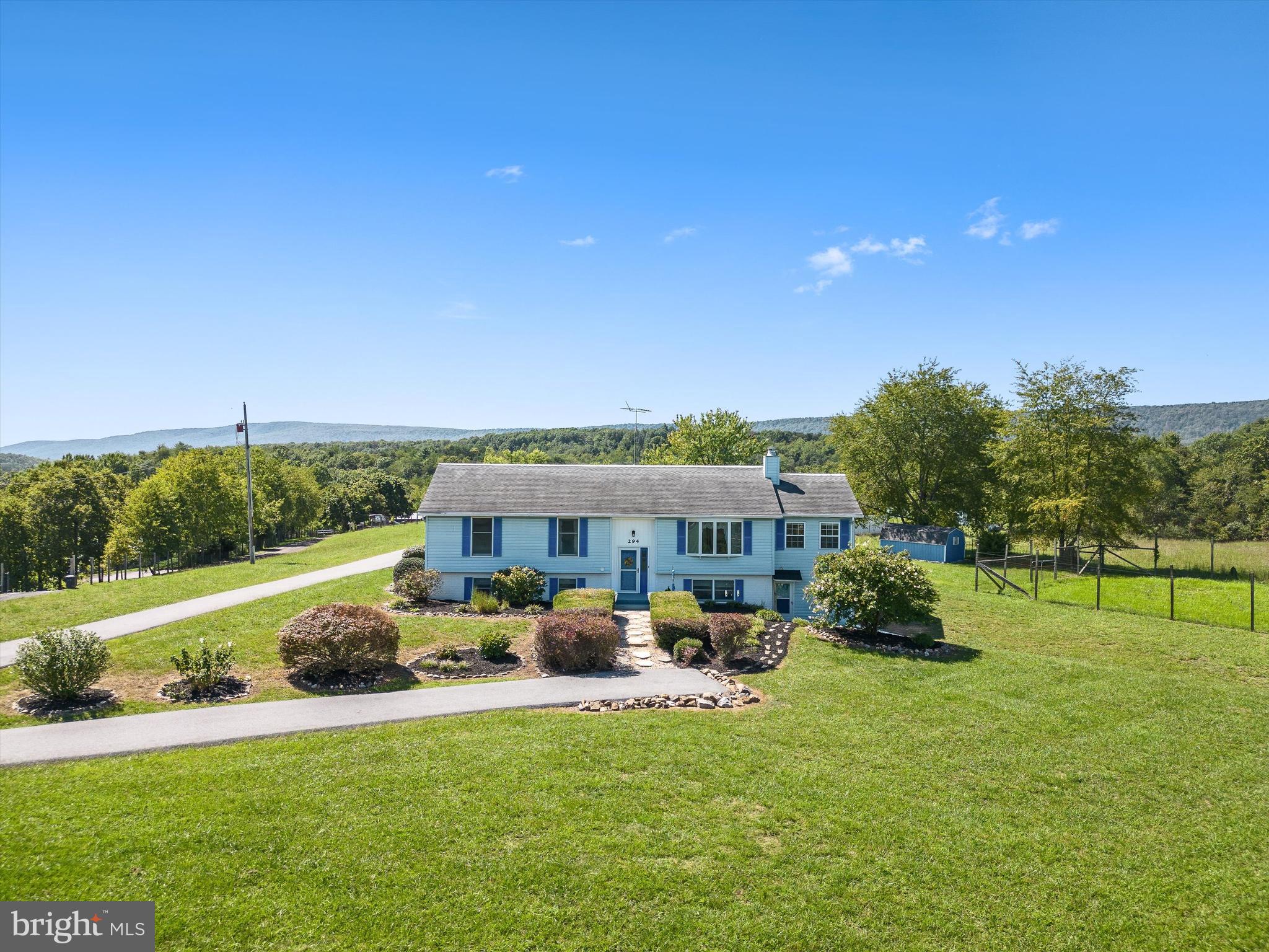 $25k PRICE REDUCTION! Bring the horses or goats! This 8-acre property includes a fenced paddock, barn area, and a small cottage in addition to a well cared for 3 bedroom 2.5 bath home with a solarium addition and oversized 2-car garage! Take in a deep breath and come home to mountain views. This home is located on a quiet country lane with large lot properties all around. Inside, this three-bedroom, two-and-a-half-bath home has a very large eat-in kitchen with large pantry and mudroom, oversized 2-car garage with work bench and storage area. Wrapping around two sides of the house is a solarium that brings in the light and has great views. The living room with a bay window leads back toward the primary bedroom with attached full bath and two additional rooms that share a hall bath. Downstairs is a fully finished basement with laundry area, half bath, wood burning stove and all the square footage you can imagine! Outside, three sheds, a barnyard area, and an old cottage await your creativity! ***This house is located in the countryside within an easy drive to Winchester, VA. Vacant and ready to show- a Must see!