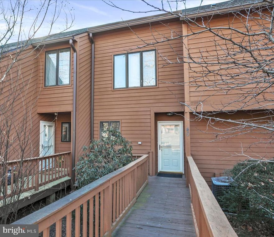 Welcome to 40 Tecumseh Trl. located in The Woods Resort where every day feels like a vacation! Experience the perfect blend of relaxation, recreation, and refined living in this beautiful two-bedroom townhome nestled in the heart of The Woods Resort community. Thoughtfully designed for today’s lifestyle, this residence offers both privacy and stunning natural beauty.  Step inside to find a large open floor plan with a a living/dining combination that features a raised brick hearth fireplace. For added relaxation, step out to the balcony that overlooks the golf course and a lovely water feature flanked by a mountain range. The great space offers new lvp flooring for a new, fresh look. The kitchen with oak cabinetry boasts a large pass-through with a breakfast bar perfect for entertaining.  The upper level is where you will find the primary and secondary bedrooms, each with their own private bath, creating ideal personal retreats for you and your guests. The primary suite is a true sanctuary—featuring a luxurious soaking tub, generous closet space in both closets, and a private balcony overlooking a tranquil water feature, golf course, and breathtaking mountain views. The upper-level laundry makes chores a breeze. The huge lower level provides flexible space for entertaining, hobbies, or a cozy family room—and opens directly to a private patio, perfect for enjoying peaceful mornings or quiet evenings surrounded by nature. 
Recent updates include new luxury vinyl plank flooring and plush carpet, adding style, comfort, and durability throughout.

Class B membership for purchase accompanies this beautiful home. Enjoy access to two championship golf courses, three sparkling pools, a modern fitness center, basketball, tennis and pickleball courts both indoor and outdoor. An active, friendly community that offers endless opportunities to relax or connect. Whether you’re seeking a weekend getaway, a primary home, or a peaceful retreat, this property delivers the best for every day living, a weekend getaway or airbnb. Only an hour and half from the DMV makes this a perfect opportunity...don't let it pass you by, schedule your private showing today!