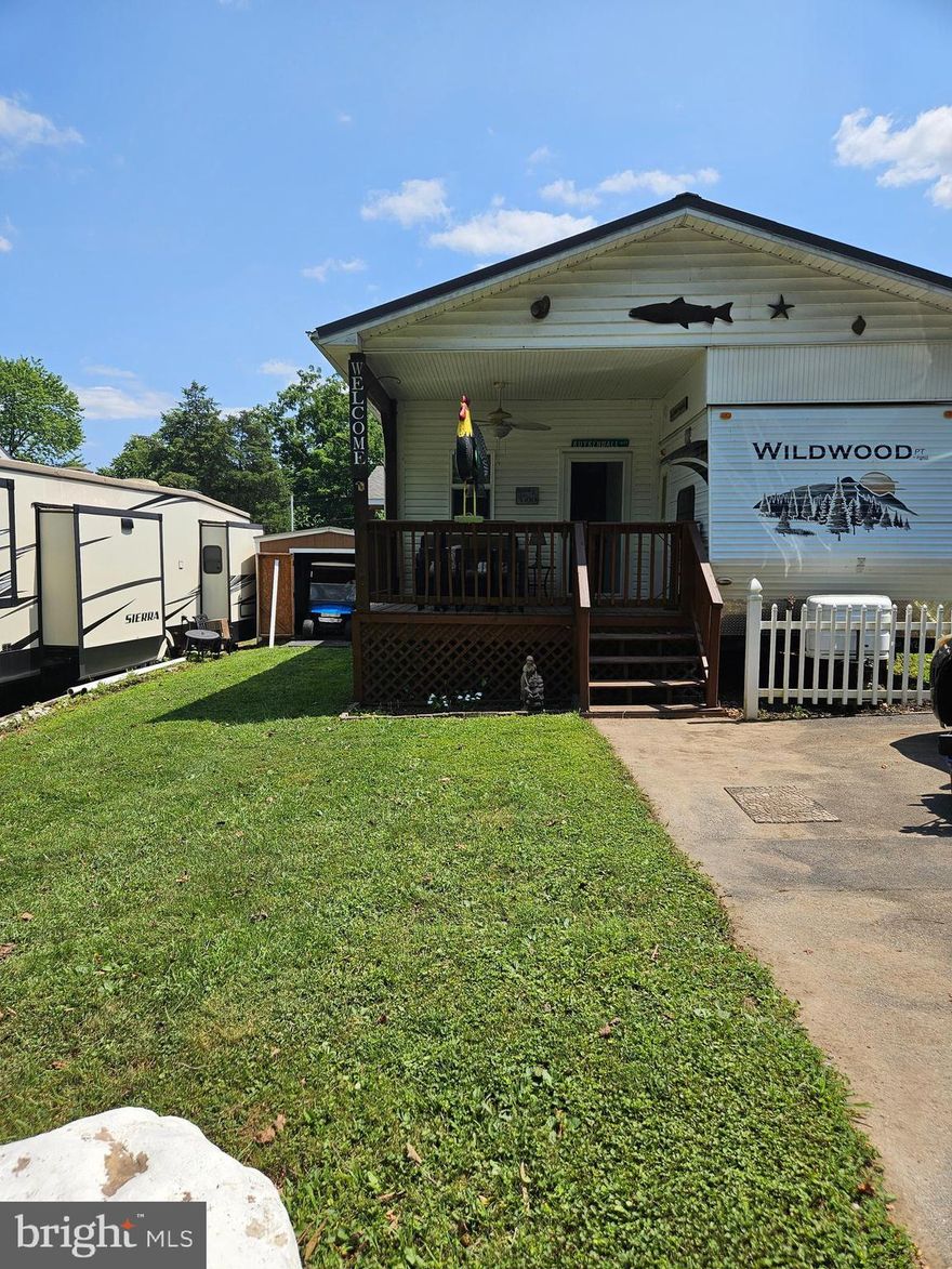 Welcome to Riverbends Block 11 Lot 16 Hot Springs Ave on SEWER in Riverbends Rv Campground. Riverbend is 400 Acres of SEASONAL recreational campground full of amenities located on the Potomac River in Falling Waters, Wv. OPEN APRIL 1 - NOVEMBER 1 - This is a fun & entertaining community, yet relaxing. 

Block 11 Lot 16 includes a well taken care of 2008 Wildwood camper that has 2 bedrooms (One on each end of the camper) One is a Queen size with lots of storage space and desk area and the other has a twin bed and a half bath with its own entry way. In the kitchen you'll find a full size refrigerator, extra appliances and more. This camper also has a tub / stall shower and a standard toilet. Attached is a beautiful 21 * 11 bonus / living room, and a 7 * 8 Laundry room with a full-sized stackable washer and dryer built on to it giving extra living space to spend the entire season here or just for the camping weekends and can invite your friends and family in. Almost everything you see conveys including the 36 V Electric golf cart and 2 chargers and a shed with electric. Spend your mornings on the 12 * 8.5 covered porch with a fan to keep the air moving or wind down your evenings out here. Perfect flat yard and paved driveway large enough for 2 vehicles. You aren't going to want to pass up this one. Schedule your showing today! 

Bring your camping chairs to make smores and memories here around a campfire. This is the spot! Approx. 10 miles of Deep water on the Potomac River access for boating, fishing & swimming. Yearly membership ($1,775) plus a $200 initiation fee for new owners, includes water, this one is on sewer, electric, trash and the park amenities such as 3 pools, putt putt course, Horseshoe club, Boat club, Poker runs, Trick or Treat, Christmas in July, live bands, basketball court, tennis court, fireworks, car show, Church, restaurant, bar, convenience store (Great food), playground, volleyball, ball field and much much more. Bring your golf carts, water toys and come enjoy life!