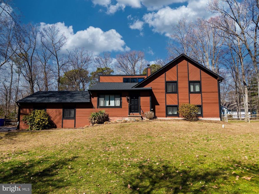 Discover the charm of this beautifully renovated split-level home in the desirable Prospect Bay community. With 4 spacious bedrooms and 3 full baths, this residence boasts an inviting interior featuring upgraded countertops, LVP floors, and cozy exposed beams. The heart of the home is the combination kitchen/dining area, perfect for gatherings, complemented by a warm wood-burning fireplace in the living room. Step outside to enjoy a serene 1.22-acre corner lot with firepit and expanded deck, backing to lush trees, offering a peaceful garden view. The community amenities include a pool, golf course, and playgrounds, fostering a vibrant neighborhood spirit. Enjoy easy access to the Prospect Bay sanctuary for boating and fishing enthusiasts. Located in a friendly community with excellent schools and nearby parks, this home is perfect for those seeking comfort and convenience. With a 2023 renovation, this property is move-in ready, offering a perfect blend of modern living and natural beauty. Experience the warmth of home in this inviting space! BONUS: Outdoor Office with private entrance on back right corner of house.