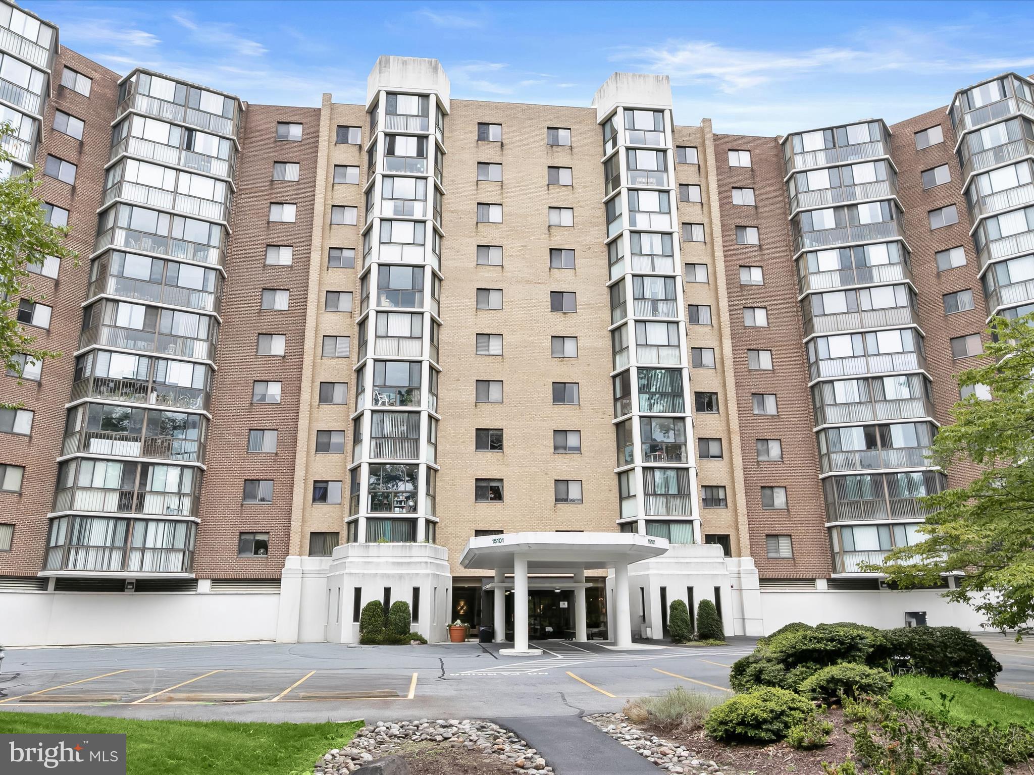 Experience luxury living at its finest in the prestigious Leisure World 55+ community of Silver Spring, MD, offering an unmatched lifestyle with world-class amenities, including tennis courts, an indoor and outdoor pool, an 18-hole golf course, billiards and ping-pong rooms, meeting spaces, an auditorium, a lounge with bar, a library, art classes, pop-up shops, and the scenic Daffodil Park with walking and biking trails. This east-facing residence with west-facing golf course views from the enclosed balcony blends comfort and elegance. The welcoming foyer features abundant storage and beautiful tile flooring that flows into the spacious living and dining area, complete with plush carpet, high ceilings, and a custom-built organization system. The kitchen, with balcony access, boasts stainless steel appliances, a pantry, generous cabinetry, and durable vinyl flooring. The private south-wing primary suite offers plush carpet, a walk-in closet plus a double-door closet, a dual vanity, and a separate water closet with a walk-in shower. Two additional bedrooms, one with double closets and a built-in desk, and the other with a walk-in closet, share a well-appointed hall bath. A one-car parking spot and perfectly situated near I-270, I-495, and MD-200, this home offers seamless access to Baltimore, Washington D.C., and beyond.