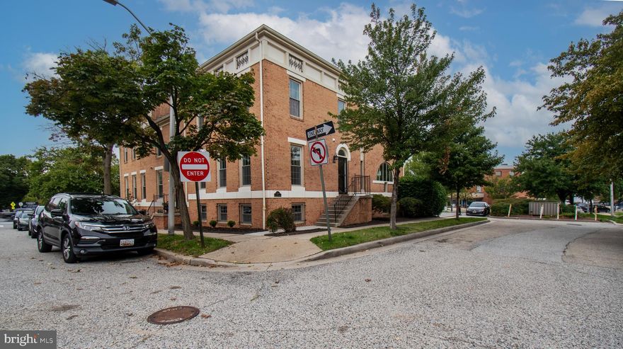 Open House This Saturday 10/25 Noon-2pm!  Enjoy the best of city living in this beautiful end-unit townhome on a charming street in the heart of Canton! Walk to the waterfront, shops, gyms, restaurants, and entertainment—everything you need is right outside your door. The remodeled kitchen features Silestone countertops, an induction range with double oven, and sliding glass doors to the deck and lower patio. The main level offers a cozy living room with fireplace and hardwood floors, plus a stylish study with built-ins and French doors to the deck. Upstairs, the primary suite includes a modern remodeled bath, convenient laundry, along with a second bedroom and remodeled full bath. The fully finished lower level features a family room with wood-burning fireplace, full bath, guest room, and plenty of storage.  New carpet throughout!  Includes one assigned parking space with EV charger and guest parking in a private lot. Don’t miss this beautiful Canton gem!