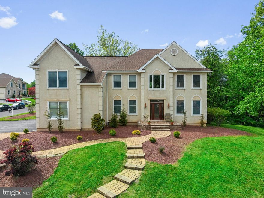 Welcome to a truly exceptional offering in the prestigious Hills at Northampton neighborhood in Holland. Situated on a corner wooded lot, this home boasts over 5,000 square feet of finished living space. Extensive crown molding, custom trimwork and recessed lights flow throughout the home, complemented by abundant natural light and elegant architectural details. The dramatic two-story family room serves as the heart of the home, featuring coffered ceilings, skylights, and a stunning floor-to-ceiling custom wood mantel over the wood burning fireplace. The adjacent kitchen features ample cabinetry, a double wall oven, cooktop, island and granite counters. This connects seamlessly to the combination living-dining room creating a functional and inviting layout. The first floor is finished with a dedicated office, powder room and spacious laundry room. Upstairs you will find a luxurious primary suite featuring a sitting area and generous closet space along with a stunning newly renovated primary bathroom. This level is well-appointed with a Jack-and-Jill bath, hall bathroom and three spacious bedrooms each with recessed lighting and ceiling fans. Additional highlights include two-zone HVAC, 3-car garage and oversized driveway, a finished walk-out basement with an additional bedroom and half bathroom, and a two-tiered deck that expands the living space outdoors. Located within the highly acclaimed Council Rock School District, this home combines timeless elegance, modern convenience, and an unmatched neighborhood setting. Perfectly positioned to offer the best of both worlds, moments from everything yet peacefully tucked away. Enjoy quick access to Newtown, upscale shopping, and an exceptional variety of dining options, along with the natural beauty of Tyler State Park. Commuters will appreciate the convenience of nearby commuter rail stations as well as effortless access to I-95 and US Route 1 and the PA turnpike. Simply unpack, settle in, and start enjoying the lifestyle you’ve been waiting for. Homes of this caliber and exclusivity rarely become available, schedule your private showing today.