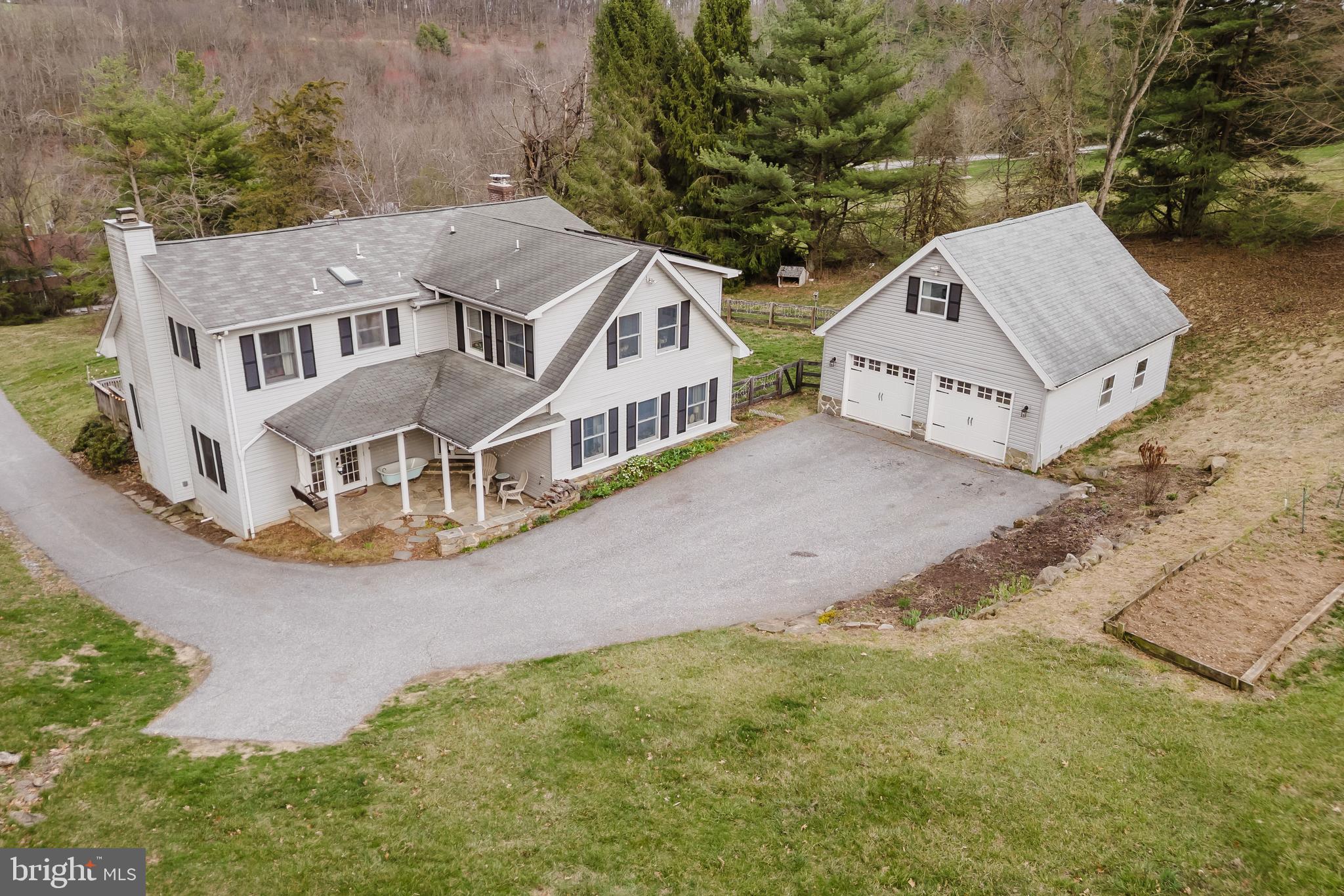 This rural retreat offers the perfect blend of privacy, modern updates, and country charm. Set on 5.75 acres, this 6-bedroom, 3.5-bath farmette provides breathtaking scenery while being just 5 minutes from I-83. Enjoy the best of both worlds with high-speed internet access in this tranquil setting. Recent upgrades include updated HVAC, roofs, heat pump electric hybrid hot water heater and a Quadra-Fire wood stove in the living room. Two bedrooms feature en-suite baths—one on the main floor and an upper-level suite with vaulted ceilings, skylights, hardwood floors, and a spa-like bath with a soaking tub and dual-sink vanity. The additional three bedrooms are spacious, with ceiling fans and ample natural light. A convenient second-floor laundry makes chores effortless. The kitchen boasts abundant cabinetry, Silestone countertops, a breakfast bar, and a dining area that opens to an expansive TimberTech deck (20x20). The great room, with vaulted ceilings and a wood stove, flows seamlessly to the screened-in porch (18x18) overlooking the valley. A stone-front porch with a ceiling fan provides the perfect spot to start your day with a warm drink. Outbuildings include a 24x30 detached garage (built in 2016) with a second-floor currently used as an art studio, wired for 220V and ready for an EV charger or solar panels. Additional structures include a 12x20 tractor shed with electric, workbenches, and wood storage, plus a 30x36 two-stall barn with hay and equipment storage. The beautifully landscaped property features 3 acres of fenced pasture, 1 acre of wooded area, and 2 acres of yard. Recent system updates include a 2020 oil heat and AC system for the main home, a second-zone heat pump/AC for the 2005 addition. The home is also near Deer Creek, stocked annually for fishing, and enjoys views of the Stewartstown passenger train passing through the valley on select weekends. A true rural oasis with modern conveniences—don’t miss the opportunity to make this one-of-a-kind property yours!