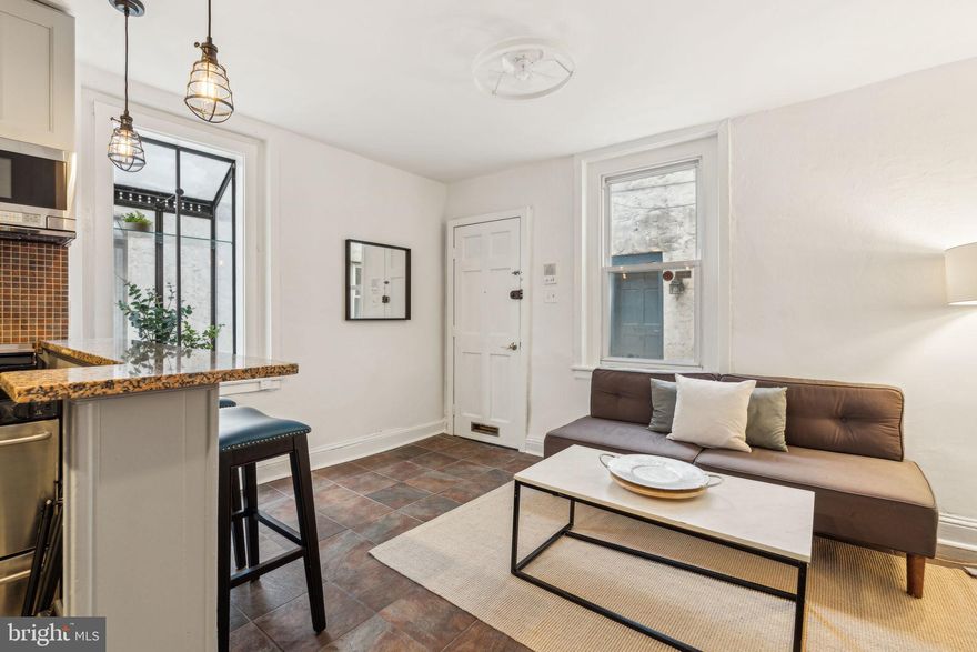 Darling Trinity home in a gated, shared courtyard setting, just off of leafy Naudain Street in South Rittenhouse Square.  This bright and inviting home offers the perfect blend of traditional charm and modern comfort. Enter the courtyard through the gate to your own secure, peaceful retreat in the city. Inside, the open living room and kitchen feature stylish tiled floors for durability and cleanliness, wood cabinetry, a bar counter for morning coffee or evening meals, the sweetest petite greenhouse window, modern stainless steel appliances, and granite countertops.  Up the box winder stair, the second floor includes a well-sized bedroom with a closet and a full three-piece bathroom complete with a classic tub/shower combination and efficient sliding barn door.  The third-floor bedroom is airy and spacious, boasting vaulted ceilings, large closets, tiled floors, and three new windows that fill the space with natural light. A clean cement basement provides excellent storage, mechanicals and laundry. This well maintained home includes a new roof (2023), central air, and ceiling fans on every floor. Located in a true rider, biker, and walker’s “paradise", you're just steps from the Schuylkill River Trail, Rittenhouse and Fitler Squares, and South Street’s shopping and dining scene, with popular spots like Sabrina’s Café, Café Lutecia, Ants Pants, Southgate, Pub & Kitchen, CityFitness, Lombard Swim club, and so much more all nearby. Quiet, convenient, and full of charm — this adorable house is a wonderful alternative to a condo with no association fees and offers a great city lifestyle.  Come see it today!