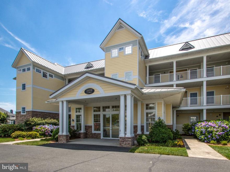 This unit is being sold completely furnished with a few exclusions. Step outside onto your first-floor private patio and take in sweeping golf course views and refreshing bay breezes. The patio is enhanced with a pergola, providing both charm and shade for outdoor relaxation. Welcome to Windswept Condominiums in The Peninsula, Coastal Delaware’s premier private gated country club community, where luxury living meets a resort-style lifestyle. 800 acres located on the Indian River Bay with a private sandy beach. This Windsor model is one of ten built. This generously sized two-bedroom residence offers a setting overlooking the 6th green of the renowned Jack Nicklaus Signature Golf Course, with captivating sunrise views that set the tone for peaceful mornings and relaxing days. Ideally positioned just steps from the Clubhouse, this home provides effortless access to world-class amenities, dining, and social activities, making it equally well-suited for full-time living or a coastal retreat. The thoughtfully designed floor plan feels bright, open, and inviting, enhanced by 9-foot ceilings throughout and a desirable southern exposure that fills the home with natural light. The main living areas feature easy-care luxury vinyl plank flooring for a cohesive and modern look, while the bedrooms are comfortably carpeted, and the kitchen and baths are finished with durable ceramic tile. The well-appointed kitchen is designed with both functionality and style in mind and will delight those who enjoy cooking. It features gas cooking, microwave, ample counter space, and a smart layout that simplifies meal preparation and cleanup. Dishwasher and refrigerator with icemaker are included. A convenient breakfast bar is perfect for casual dining or entertaining, while the adjacent dining area offers space for more formal meals. The open concept living and dining areas are anchored by a gas fireplace. It is flanked by beautiful Maple built-in bookcases and storage cabinets creating an ideal setting for gatherings or quiet evenings at home. The primary bedroom also enjoys these stunning views and features plantation shutters, offering excellent light control for restful mornings. The ensuite bath includes a double-sink vanity, a walk-in closet, and a private bathing area with a soaking tub, separate shower, and toilet—designed to provide comfort, privacy, and convenience. The guest bedroom offers access to a private bath, walk-in closet, ceiling fan and plantation shutters. One of the most distinctive features of this residence is the additional family room, making it one of only five condos in Windswept with this enhanced layout. This versatile space is ideal for a second living area, media room, or home office. A stylish Murphy bed has been installed to comfortably accommodate overnight guests without sacrificing everyday functionality. A few homeowners have converted this into a third bedroom. A separate laundry room includes a washer and dryer. The adjacent utility closet hides the hot water heater and HVAC. An additional highlight is a newer HVAC heat pump installed in 2018, adding peace of mind and energy efficiency. Enjoy the convenience of the large storage room just steps from your front door, as well as your assigned parking space just steps from the welcoming lobby. The HOA and condominium fees cover an impressive array of services, including Verizon FIOS Internet and TV, common area, road maintenance, trash collection, 24/7 security, and contributions to long-term reserves for future capital improvements. Residents of The Peninsula enjoy access to an unparalleled lifestyle, with club membership required and membership levels available to suit the buyer’s preferences. From championship golf and indoor and outdoor pools to fitness facilities, dining, and a vibrant social calendar, The Peninsula offers an exceptional coastal living experience. Please inquire for additional details regarding club membership and community amenities.