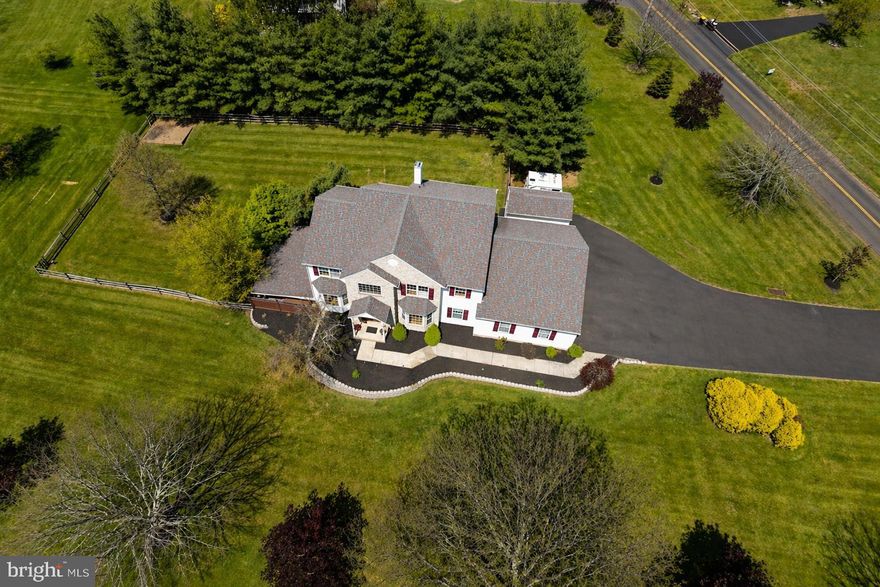 Usually there’s a compromise baked in somewhere, this one skipped that part. Welcome to 1265 Moyer Road.

Before you even step into the main house, there’s a separate driveway leading to a detached garage. Oversized door, real workspace, and a finished space above with a kitchen, living room, bedroom, full bath, laundry, its own heating system, and a pellet stove. Beautiful wood floors run throughout the space.

The main house sits on 1.5 acres in the Souderton School District and offers over 5,500 square feet of finished space. You walk into a two-story foyer with a turned staircase, a dining room on one side and an office with French doors on the other. Straight ahead, the kitchen opens up with a large island, plenty of cabinet space, and strong natural light, along with a slider out to the deck overlooking the fenced backyard. It flows right into the family room, which includes both a pellet stove and a gas fireplace.

The first floor also includes a spacious laundry room, powder room, and access to an oversized three-car garage.

Upstairs, all four bedrooms are well-sized and each includes a ceiling fan. The hall bath has been updated, and the primary suite includes a sitting room, gas fireplace, walk-in closet, and a large private bath.

The walkout basement is fully finished with wood-look tile flooring, a wet bar, full bathroom, and access to a covered patio with a hot tub.

The updates that matter are already handled. Most of the home has been freshly painted, all carpeted areas have been replaced, and the major systems include a newer roof, geothermal HVAC, backup generator, and a tankless hot water heater.

Between the main house, finished basement, and the detached garage with a finished space above it, this is a property that gives you options you don’t usually find in one place.