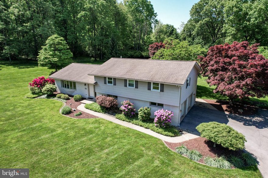 PLEASE SUBMIT HIGHEST AND BEST OFFER BY NOON MONDAY, JUNE 3! Welcome to your dream home located in Upper Saucon Twp– S. L. SD! This well maintained 4-bedroom, 3 full bath split-level is nestled on a beautifully landscaped 1.5-acre lot, offering a blend of privacy and natural beauty. Step inside and experience a spacious, thoughtfully designed interior perfect for comfortable living & entertaining. The split-level layout offers a seamless flow between living areas. Refinished hardwood floors gleam throughout all 4 bedrooms, plus the living & dining rooms. Enjoy cooking in an updated kitchen with 42” cabinets, granite countertops, modern stainless steel appliances, and plenty of room for a table. Wait till you see the view from the kitchen table. Retreat to a serene master bedroom featuring a private, updated ensuite bath, creating a personal oasis for relaxation. Four generously sized bedrooms and three full baths provide ample space for family and guests. Large 2+ car garage with extra space for storage. There's an additional room attached to the garage for a workshop, hobbies, or could even be extra living space. The expansive 1.5-acre lot is meticulously landscaped, offering picturesque views and outdoor spaces perfect for gardening, recreation, or simply unwinding. Situated in a peaceful setting, yet conveniently close to local amenities, schools, and major highways. Don’t miss the opportunity to own this exceptional home. Schedule your private tour today and imagine the endless possibilities this beautiful property has to offer.