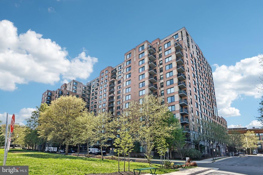 Welcome to Midtown Alexandria Station — where luxury meets convenience in this rare and highly sought-after first-floor condo that truly lives like a single-family home.

Unit #105 offers the perfect blend of comfort and style, featuring soaring ceilings that create an airy, open feel, and a private walk-out patio — ideal for morning coffee, evening relaxation, or letting pets out with ease. This exceptional unit is one of the few in the building with direct outdoor access, providing unmatched convenience and a unique sense of space.

Skip the elevator — your assigned garage parking space is just steps from your front door, making daily life and grocery runs effortless. Inside, you’ll find a modern kitchen with granite countertops and stainless steel appliances, in-unit washer and dryer, and an open-concept living and dining area perfect for entertaining.

Midtown Alexandria Station offers an impressive lineup of amenities, including a 24/7 concierge, outdoor pool and hot tub, sundeck with grills, a full fitness center, party room, cyber café, and guest suites. Located directly across from the Huntington Metro Station, commuting into D.C. or exploring Old Town Alexandria and National Harbor is a breeze.

Don’t miss this rare opportunity to own a one-of-a-kind condo that combines all the perks of high-rise living with the feel of a private home.