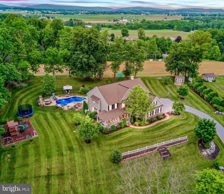 Minutes to town. a world away, one-of-a-kind. crafted, curated, meticulously maintained and improved over the past eight years. This property will dazzle with features that create a rare package - a Lititz home with ample interior space, outdoor living, breathtaking views. Yet close enough for a quick jaunt into town, major shops, places to eat and biking trails. Nestled on a 2.24 acre private lot, complete with over 4,000 square feet of living space, a resort-style backyard oasis complete with pool, slide, oversized patio deck. This 2014 custom-built Garman home is the retreat you have been searching for to brush off the dust of the stresses of modern life.  Located in highly desirable Lititz and Warwick School District with complete privacy bounded by woods. pristine farmland and even a small creek.  In the summer, enjoy your morning coffee rocking on your covered wrap-around porch.  Then head to cool off in the saltwater pool (that is heated too) after finishing up a session in your substantial exercise room.  Take a five-minute cruise into Lititz, America’s coolest small town, to grab a bite to eat on Main Street while hitting a few of the local shops, before cruising back home, up your private estate drive, to take in the million-dollar view that stretches for miles across the entire valley from your hammock under the shade of mature trees.  Gather up your supplies for S’mores by the custom 12,000 lb. stone poolside fireplace and gaze at the incredible night sky when the stars come out. Finish up your day winding down by one of two propane fired fireplaces in the house or take in a movie in your massive finished basement as you reflect on your perfect summer day.  Be Sure to Click Camera Icon to View All Photos, Drone Video and the Full 360 Degree Virtual Tour. Use your VR HEADSET to Take a Virtual Reality Tour of this home via the Kuula 360 Degree Spherical Tour link.  Call, click, or message to schedule the tour of your new estate home today!