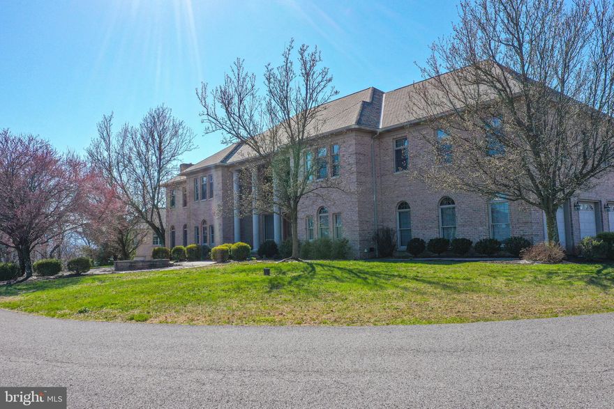 WOW! There is so much to this property! All brick custom design home located on 4.23 The interior of the home boasts 5-6 bedrooms, 6 full and 2 half baths, and stunning hardwood and ceramic floors throughout. The formal living and dining rooms are perfect for entertaining, while the bonus (piano) room with a wall of windows is a bright and welcoming space to relax or practice music. The oak woodwork throughout the house showcases exceptional craftsmanship. The kitchen is equipped with an eat-in nook and leads to a deck overlooking the spectacular view. The master bedroom suite features a large sitting room, fireplace, and master bath. The lower level features a living room area with a walk-out to the patio and an in-ground heated pool with optical lighting for relaxation and entertainment. The finished attic with hardwood floors and a ballet bar adds a unique touch of versatility to the property. To ensure comfort and efficiency, the house is equipped with 4 forced air furnaces. The incredible views from the property add to the value of this home, offering a serene and picturesque environment. Don't miss the opportunity to own this exceptional and luxurious property. Schedule a viewing today to experience everything that it has to offer.