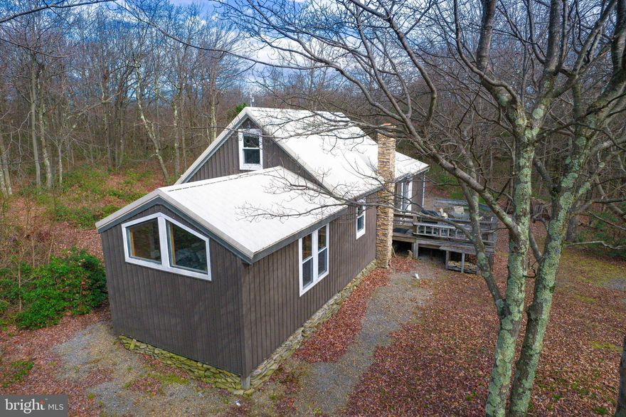 Explore 384 Scrub Oak Road, a fully-equipped mountain haven accessible all year, boasting two bedrooms, one bathroom, a full kitchen, and spacious areas for living and dining. It features a private deck and fireplace for social events. Relish the comforting glow of a stylish gas fireplace and pellet stove. The property presents updated living quarters, a new metal roof, and exterior siding. Designed to accommodate six people, this cabin is situated in Bedford County, near Omni Bedford Springs Resort, Blue Knob All Seasons Resort, and Shawnee State Park. Just a two-hour journey from Pittsburgh, Washington DC, or Virginia, it offers immediate access to outdoor activities. Located in a secure gated community, this idyllic retreat is ready for your visit.