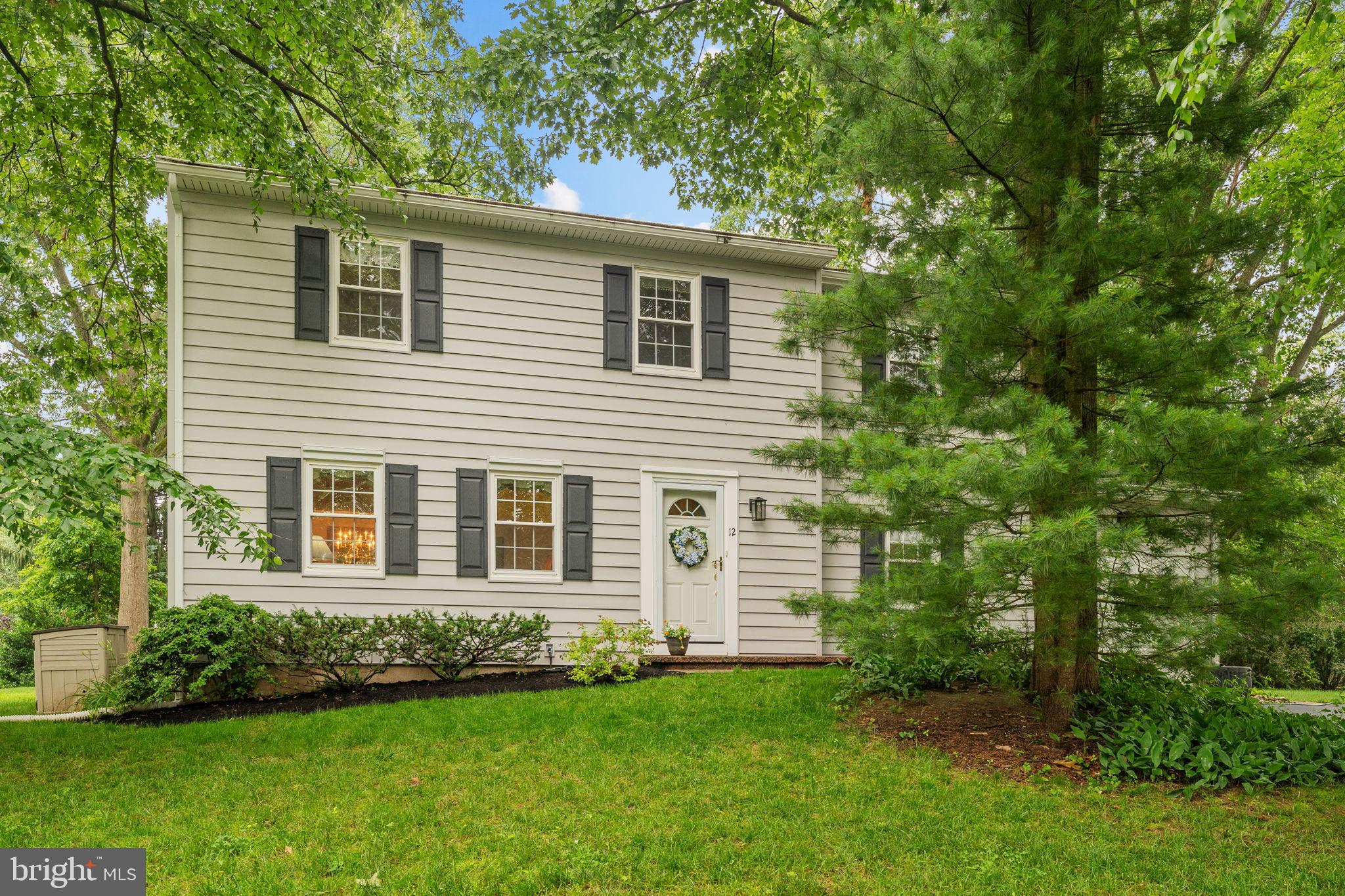 Welcome to 12 Ridge Road, a classic Colonial nestled in the heart of Malvern’s East Whiteland Township in award-winning Great Valley School District. Tucked beneath a canopy of mature trees and surrounded by lush landscaping, this charming home offers both privacy and convenience in a serene, established neighborhood. Step inside to find sunlit living spaces with gleaming hardwood floors and large windows that invite the outdoors in. The formal living room exudes warmth and comfort with classic hardwood floors. Just beyond, the elegant dining room is the perfect setting for special gatherings. The heart of the home is the beautifully updated kitchen, where crisp white cabinetry, engineered quartz countertops, and stainless-steel appliances come together in a bright, functional layout. A center island offers extra prep space, while windows overlook the vibrant backyard garden. Adjacent to the kitchen, the cozy den is a comfortable space to unwind, with a neutral palette and brand-new sliding glass doors that lead to a brick paver patio. There is easy access to the one-car garage from the den. Step outside to discover your own backyard oasis—professionally landscaped and thoughtfully designed for outdoor enjoyment. Whether you're dining alfresco, gardening, or simply relaxing with a good book, the patio and surrounding greenery create a peaceful retreat. Upstairs, you’ll find the spacious primary bedroom with an updated full bathroom and a walk-in closet. The remaining three bedrooms offer plenty of natural light and spacious closets. They share the neat, clean full hall bathroom that offers a tub/shower combination with tile surround and a single vanity. The unfinished basement offers great storage space or a blank slate for a playroom, home gym or craft room. Don’t miss this one - with its classic curb appeal, inviting interior, and beautifully maintained outdoor living space, 12 Ridge Road is ready to welcome you home. Conveniently located near top-rated schools, shops, and commuter routes, this property offers the perfect balance of charm, function, and location.