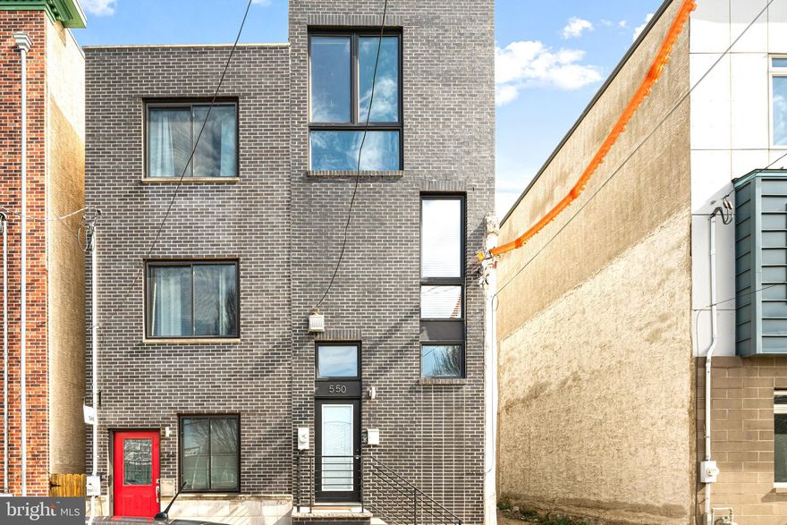 This stunning home in the heart of Fishtown boasts three floors of bright, spacious living areas, a finished basement, private outdoor space, and jaw-dropping skyline views. The free flowing layout showcases custom glass railings, beautiful hardwood floors, expansive floor-to-ceiling windows, and elegant modern details.

Conveniently located between Frankford Ave and Front St in one of Philadelphia's most sought-after neighborhoods, this home is tucked away on a quiet side street, directly across from a recreation field. Enjoy minimal through-traffic and easy access to public transportation, including the Market-Frankford Line and multiple bus routes along Frankford Ave.

The first floor benefits from open concept layout with high ceilings, recessed lighting, and an exposed brick accent wall for added classic character. The chef's kitchen features sleek black appliances, luxurious quartz countertops, shaker-style cabinets, a stylish white tile backsplash, and a breakfast bar perfect for casual dining.

On the second floor, two well-sized bedrooms flank a full hall bath showcasing an elegant design, complete with a full tub, sliding glass doors, a modern sink, and a lighted mirror. The front bedroom includes a generous closet and floor-to-ceiling windows with views of the park across the street. The rear bedroom offers ample closet space and a ceiling fan perfect for a guest room or home office.

The entire third floor is dedicated to the luxurious primary suite. The bedroom features large street-side windows, flooding the room with natural light. A walk-through closet houses two dressers with quartz countertops, overhead shelving, modern lighting, and a large mirror on the way to the spa-like bathroom. The bath offers a separate water closet, a spacious vanity with dual quartz sinks, and a luxurious shower with marble tiling,  waterfall shower head, a built-in seating area, a fogged glass window, and sliding glass doors.

At the top of it all, enjoy your private roof deck with a wet bar, perfect for entertaining and soaking in the stunning views. The finished basement features high ceilings, a front-loading washer/dryer, a half bath, and ample space that can be used as a spare bedroom or recreation room.